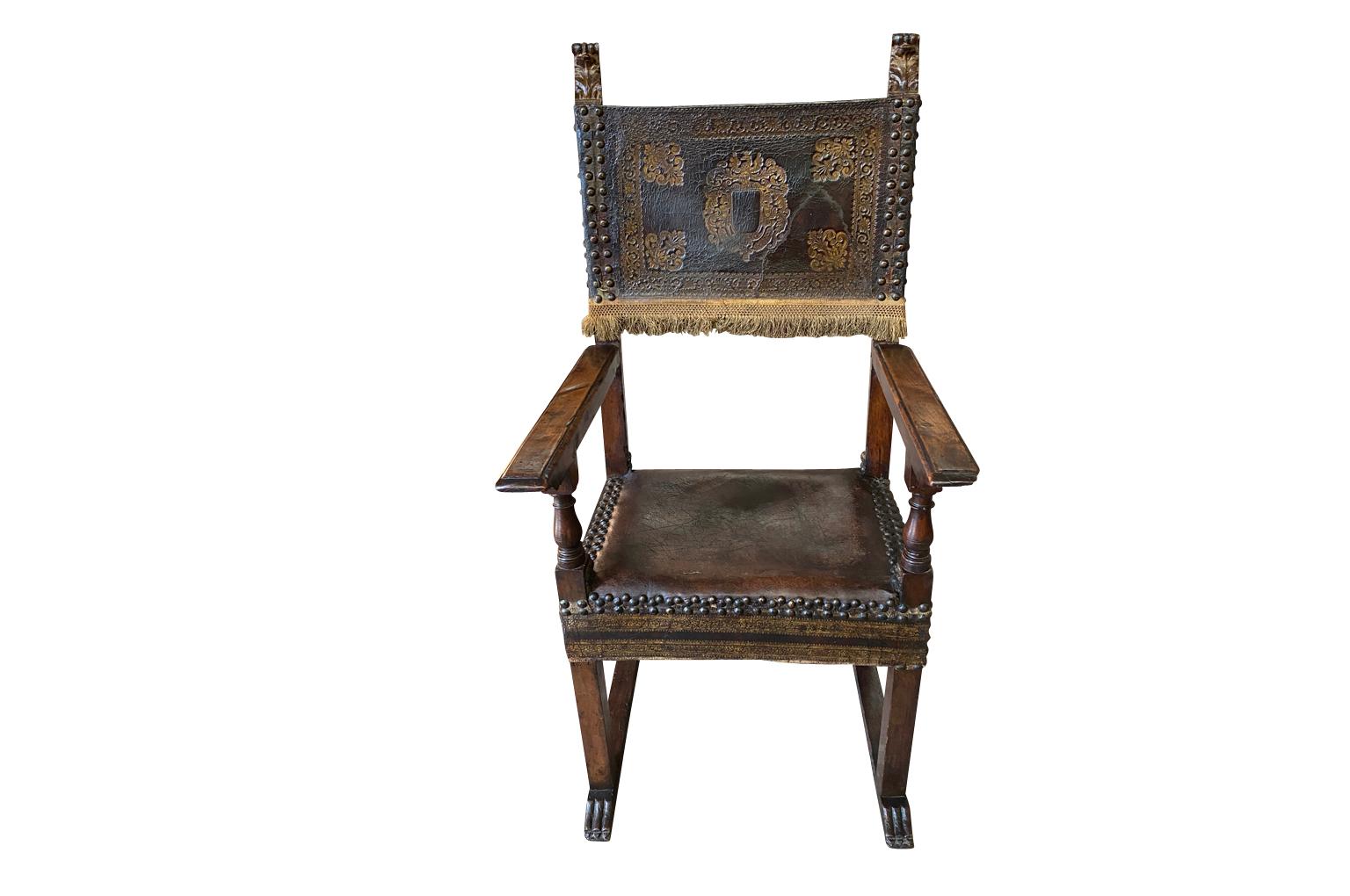An exquisite Renaissance period armchair from Lombardy, Italy. Wonderfully constructed from walnut and tooled leather accented with gold gilt and handsome nail heads. Very sturdy with wonderful patina.