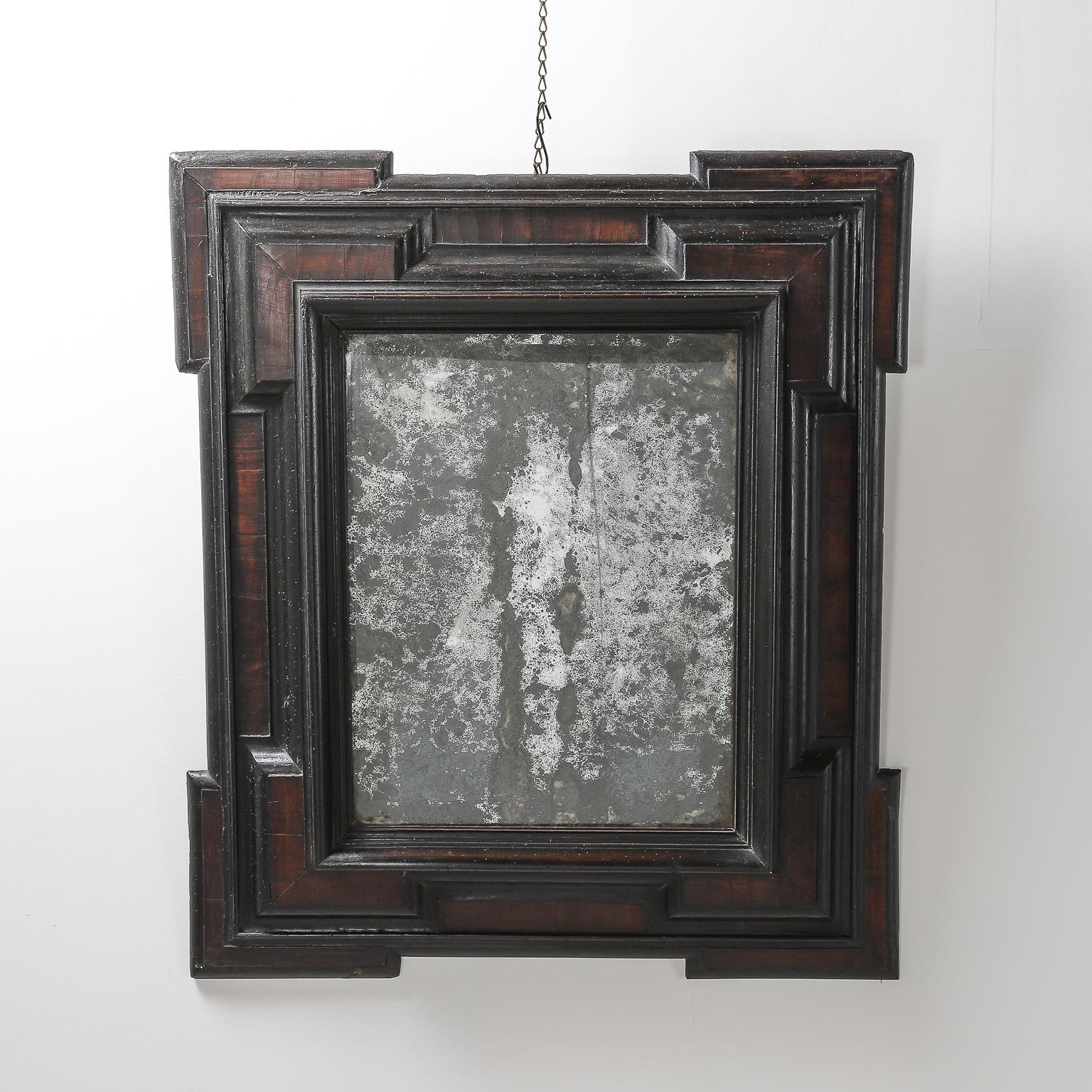 A mid-17th century Dutch Baroque walnut and ebonized mirror with geometric details with antique mirror. Ageing consistent with the age with light repairs.



 