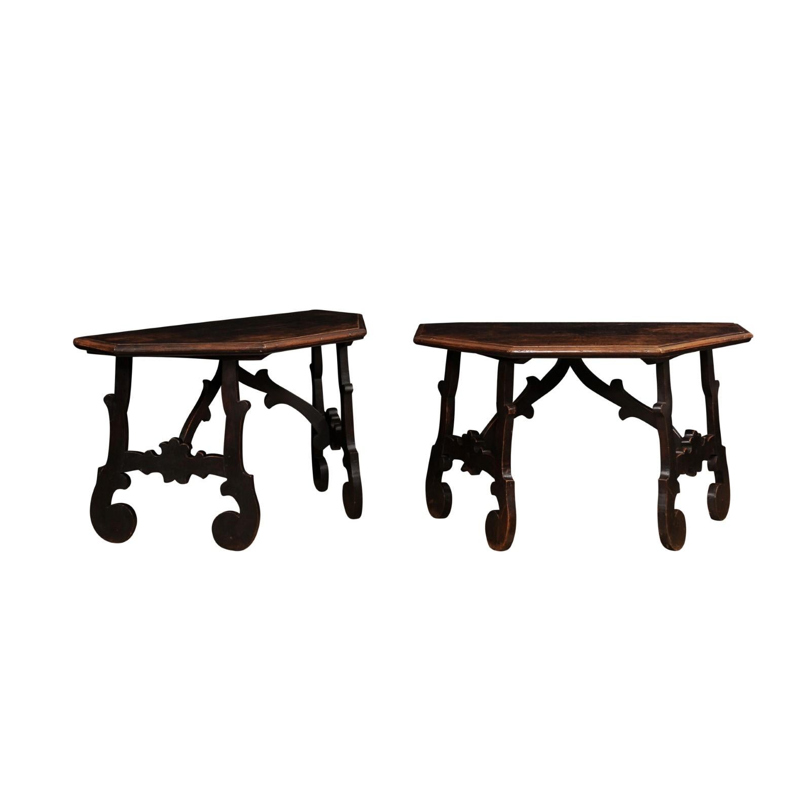 A pair of Italian Baroque period walnut Fratino console tables from the 17th century with carved lyre shaped bases and very authentic rustic character. This captivating pair of Italian Baroque period walnut Fratino console tables, dating back to the