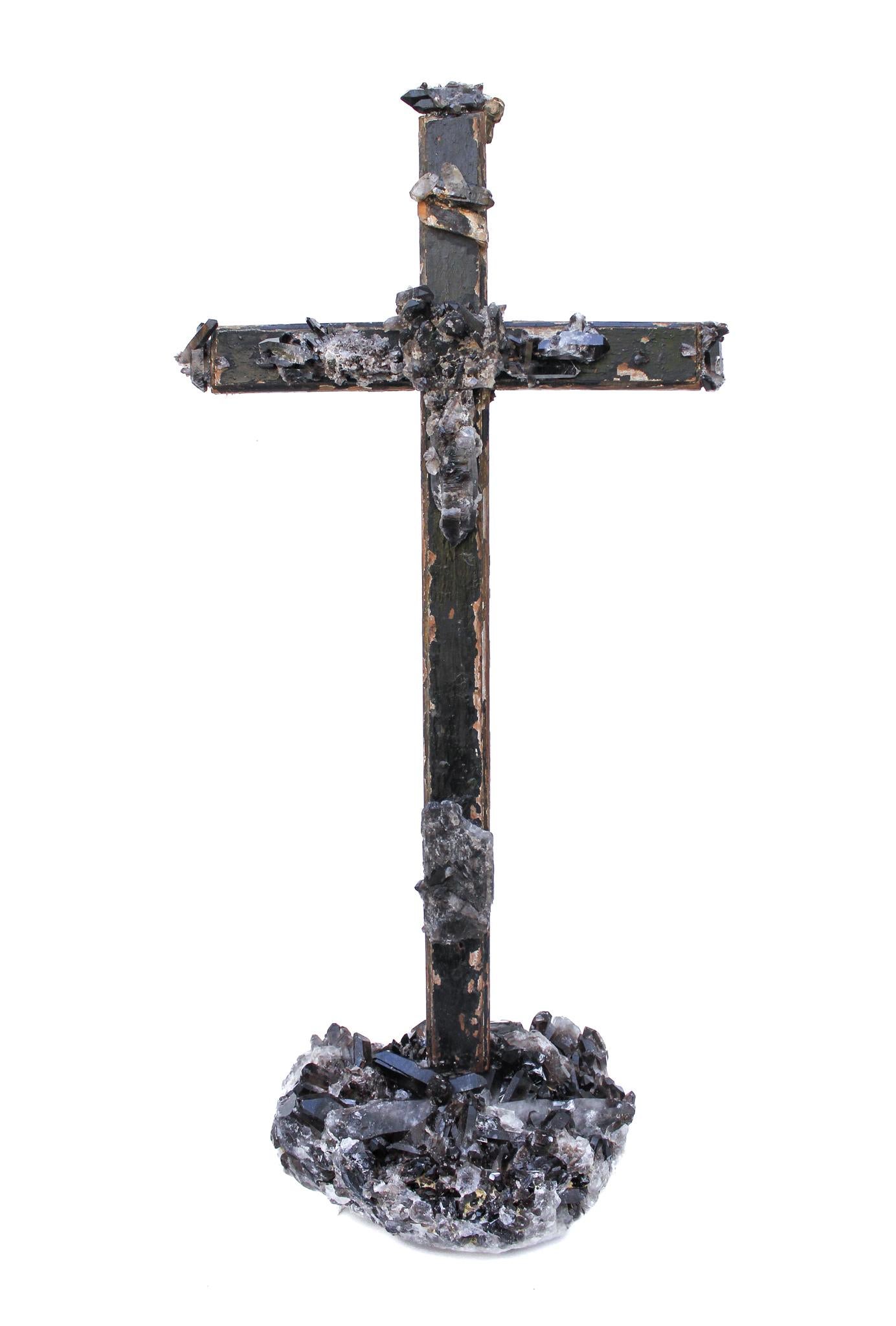 17th century Italian cross adorned with black crystal quartz points and mounted on a black crystal quartz cluster. 

The black crystals have been applied onto the cross to look as though naturally grew on the piece. The cross as a result looks