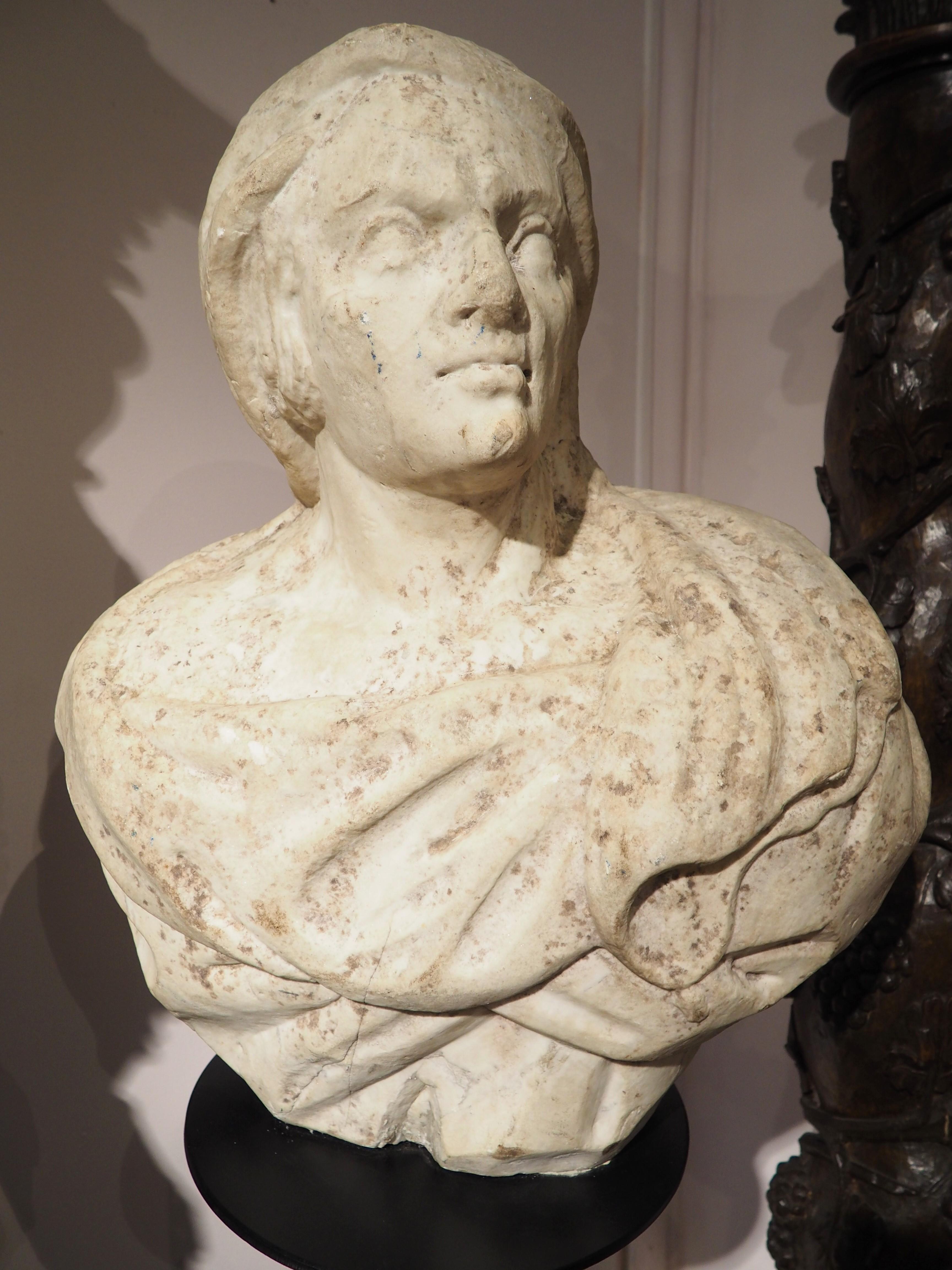 Salvaged from a villa on the Amalfi Coast in Southern Italy, this beautiful marble bust was hand-carved in the 1600’s. Our subject has a cloak wrapped around his shoulders and is depicted looking slightly to his left and upwards. The bust sits atop