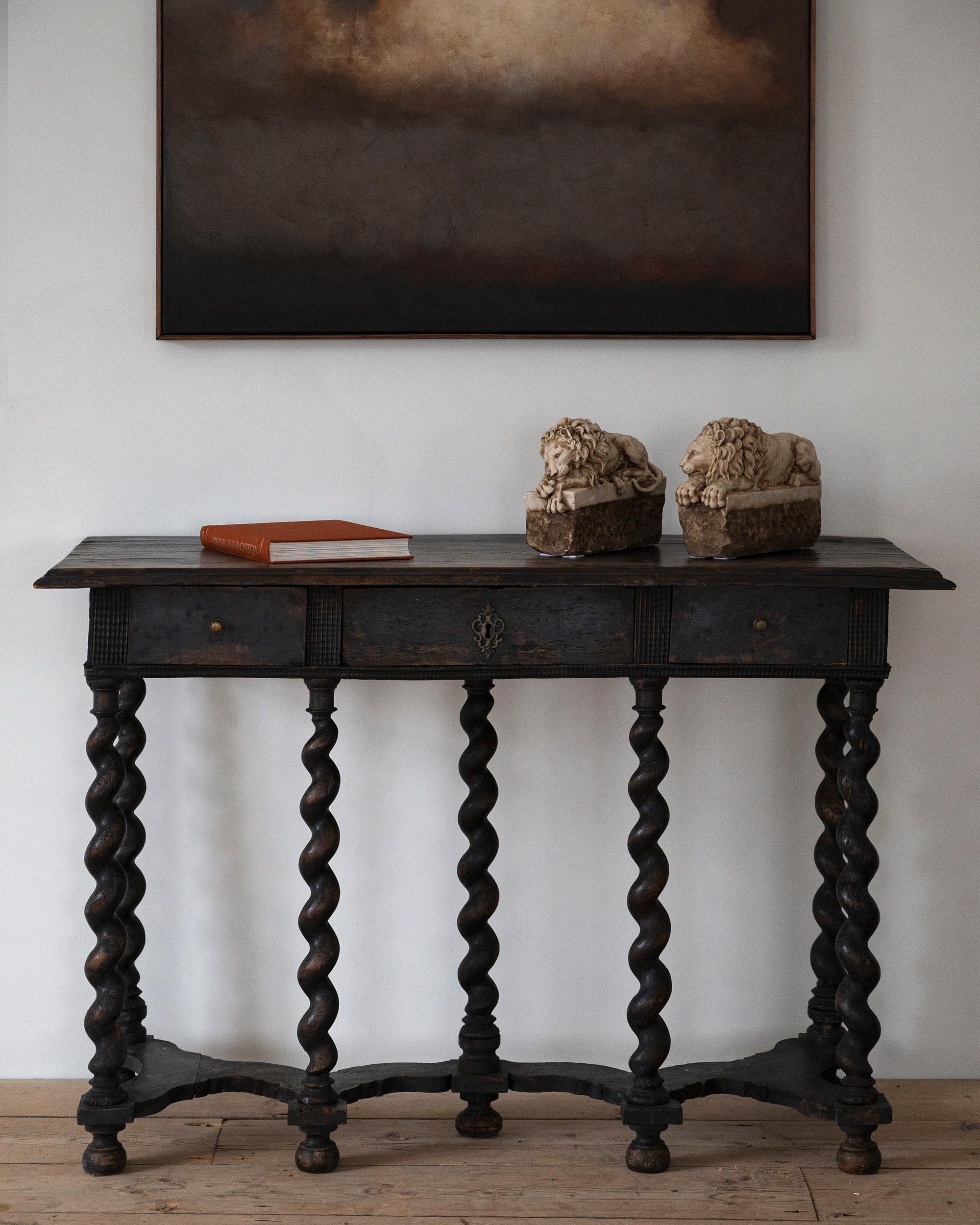 Rare 17th century Italian console table in it's original surface with amazing patination. Standing on seven twisted legs that terminate in bun feet at the base with an shaped cross stretchers. Ca 1690 Italy. 