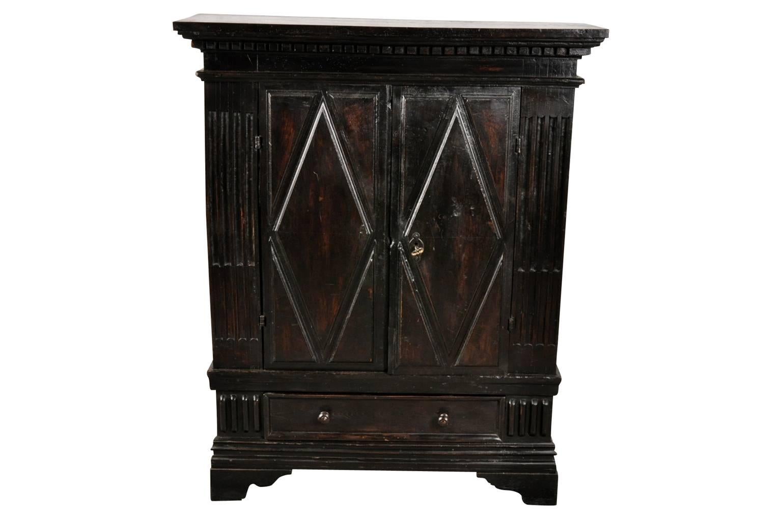 A very handsome 17th century Credenzino from Northern Italy. Wonderfully constructed from black walnut with lozenge door panels and raised on bracket feet.