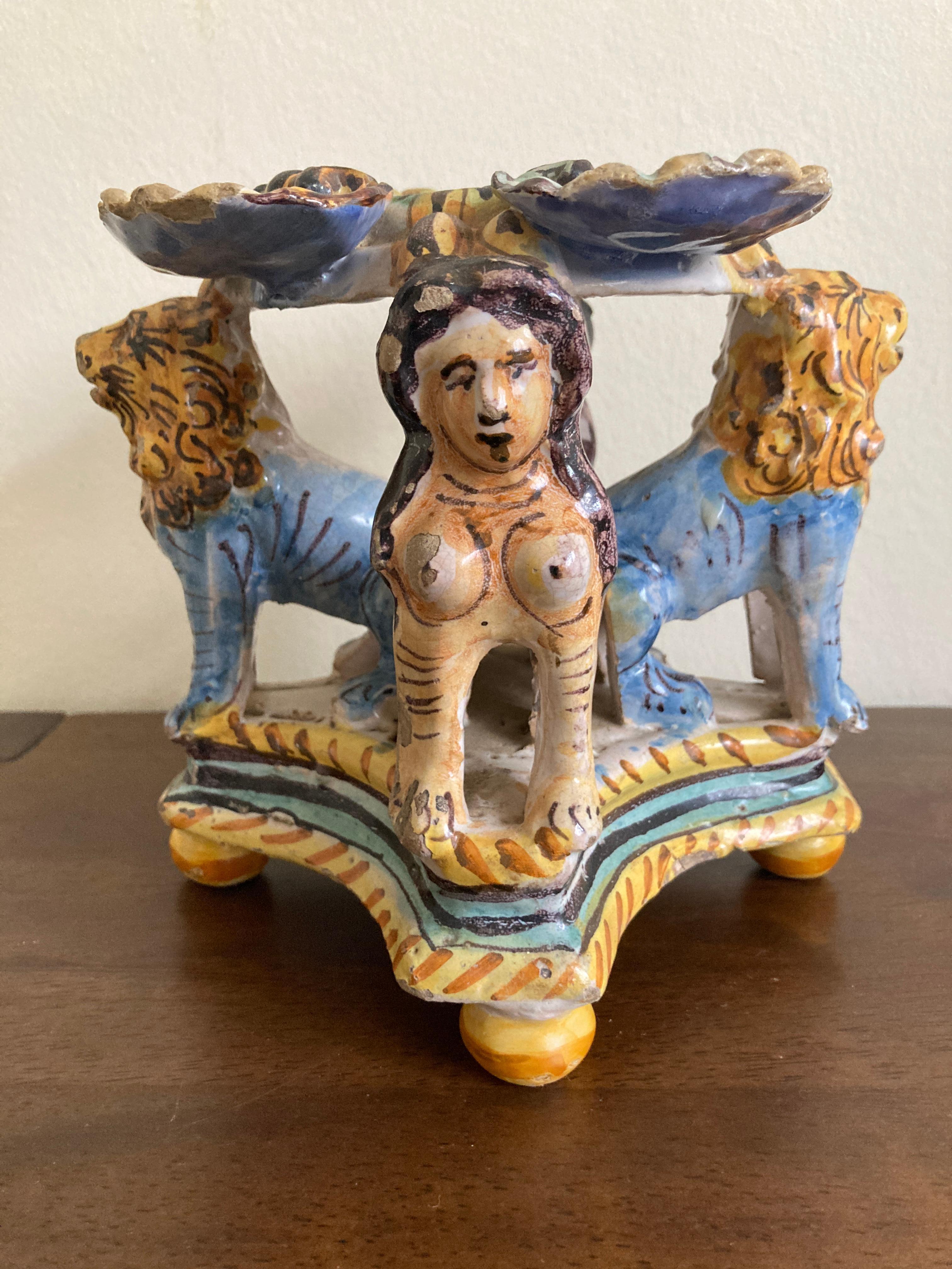 17th Century Italian Deruta Maiolica Salt, probably made in Caltagirone in Sicily, the central circular dish within four scroll dishes supported by a Sphinxes and lions on on a cross shaped base and bun feet, painted in blue, manganese and