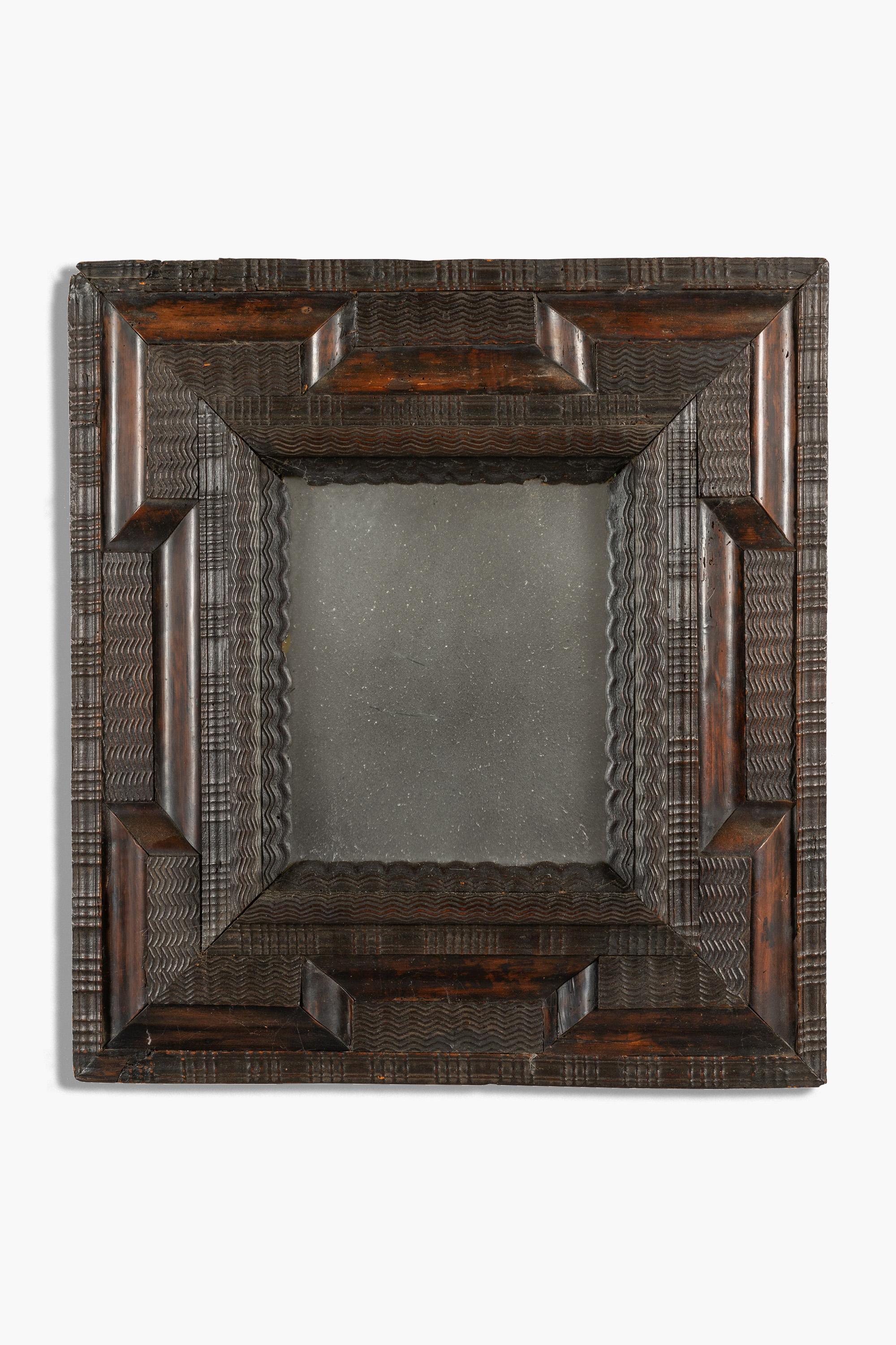 Wonderful 17th Century Italian ebonised Guilloché mirror with carved ripple moulding. Luigi XIV, Piedmont.

The rectangular plate within a cushion frame of convex and carved ripple moulding.

Minor age related and expected wear. The mirror plate