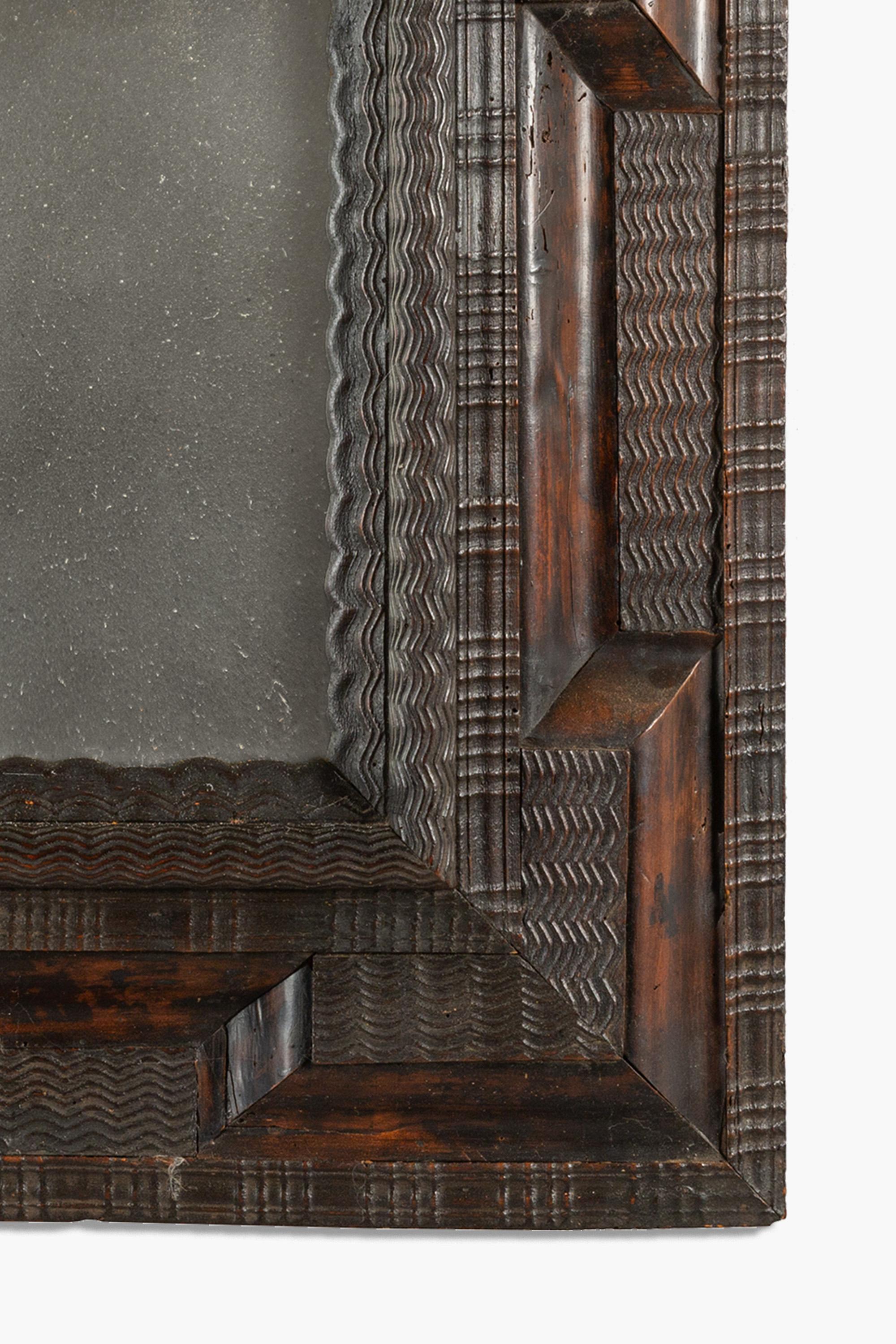Baroque 17th Century Italian Ebonised Ripple Framed Mirror For Sale