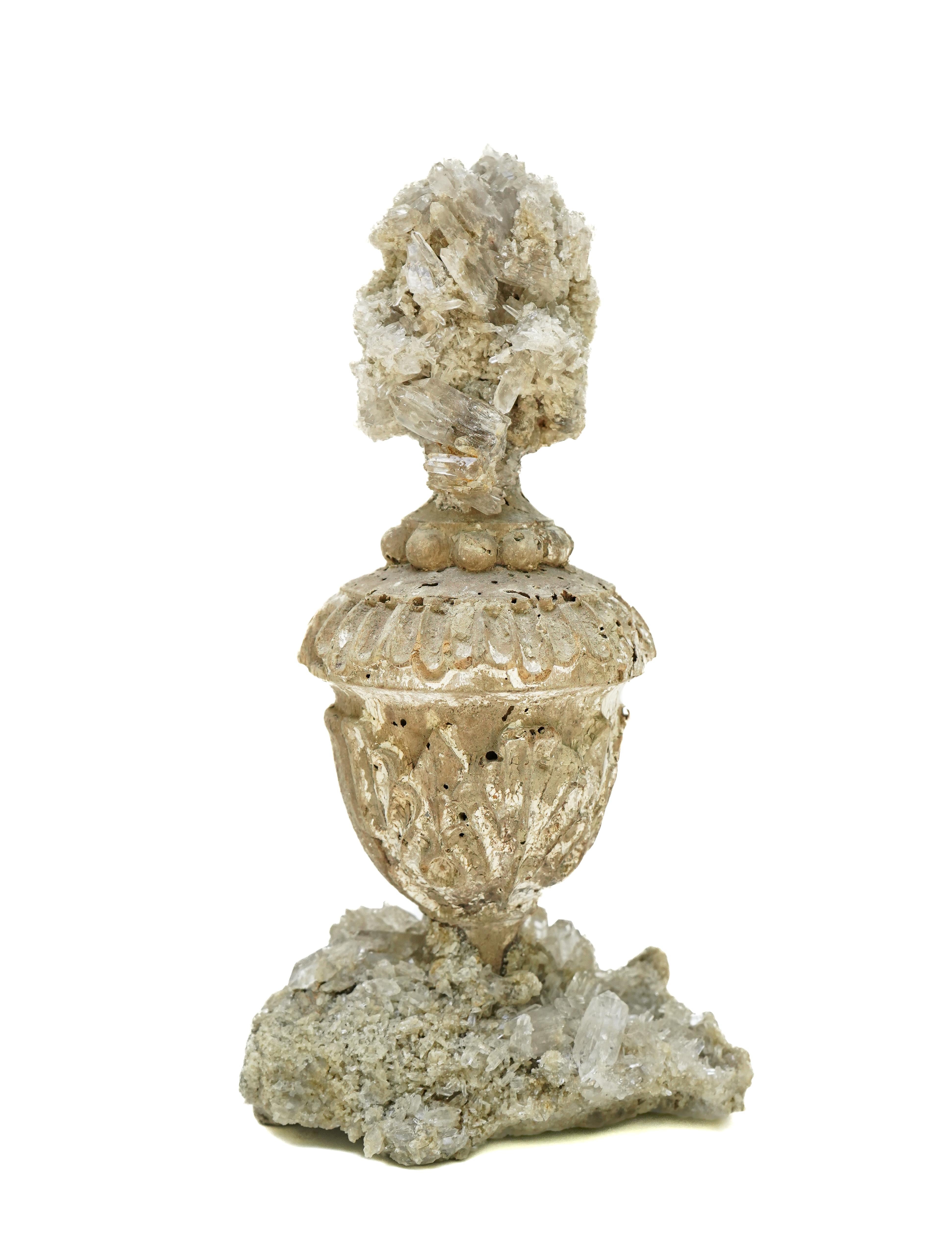 17th century Italian vase with a crystal quartz cluster on a crystal quartz cluster base.

This fragment is from a church in Florence. It was found and saved from the historic Florence Flood of 1966. This was one of the worst floods recorded since