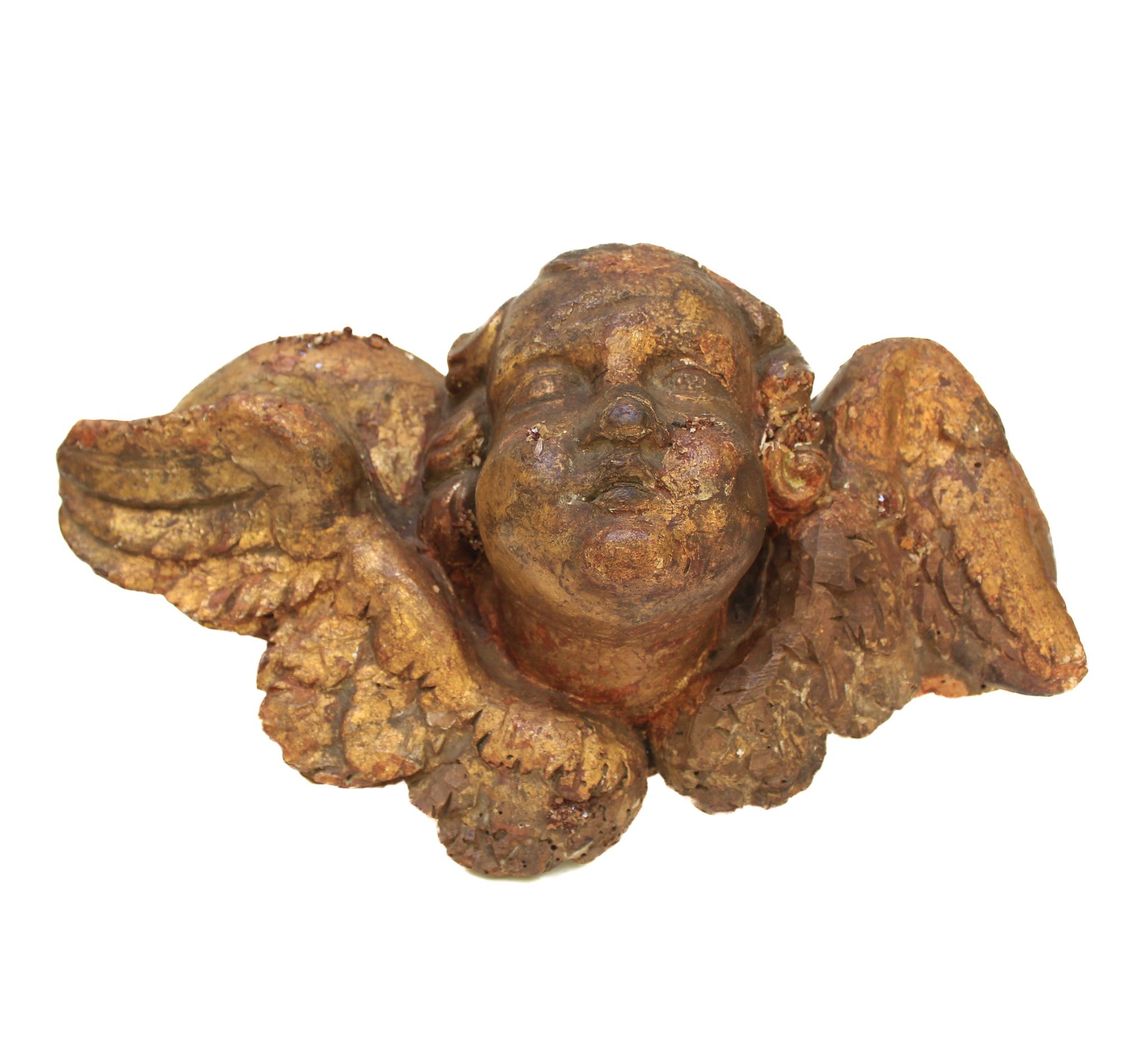 17th century Italian angel head (putto) with vanadinite crystals on a metal stand. It is adorned with the vanadinite crystals on different aspects of the piece.

A 
