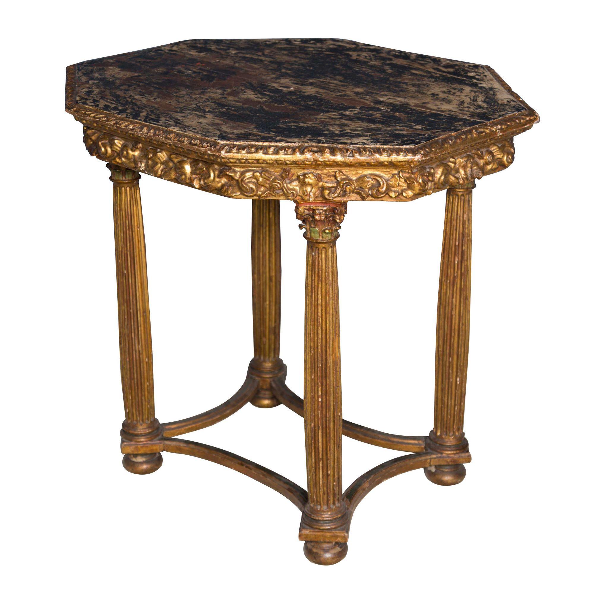 Beautiful gilded 17th century Italian table with carved reeded legs and original painted top. Wonderful decorative carving to the apron and to the tops of the reeded column legs, with elegant curved stretchers.