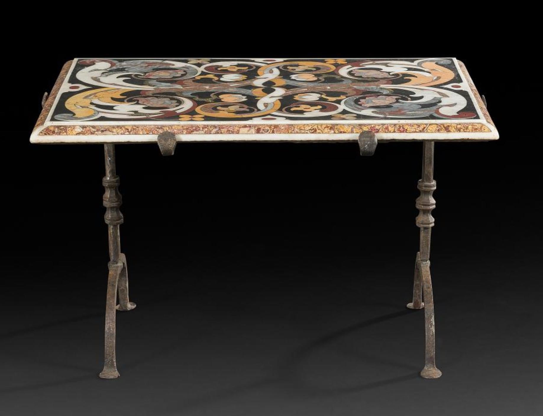 Rare multi-color marble-top inlaid table standing on wrought iron legs.
Made in 17th century in typical Florentine style with a lot of floral motives on black base.