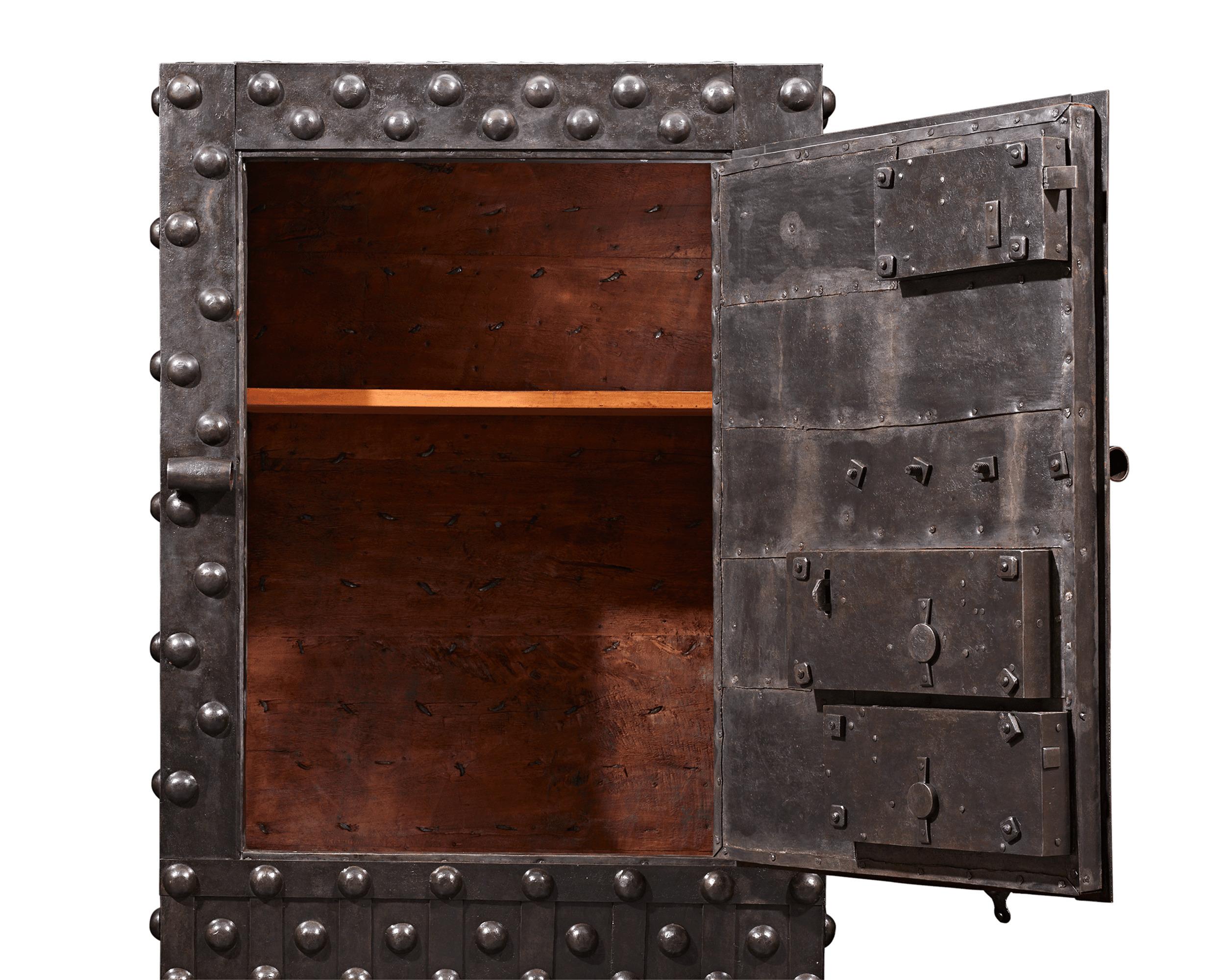 This rare Italian Baroque safe is crafted of reinforced wrought iron and is designed to be virtually indestructible. Intended to secure one's most precious valuables, the fascinating structure is enveloped in thick iron strapwork that surrounds its