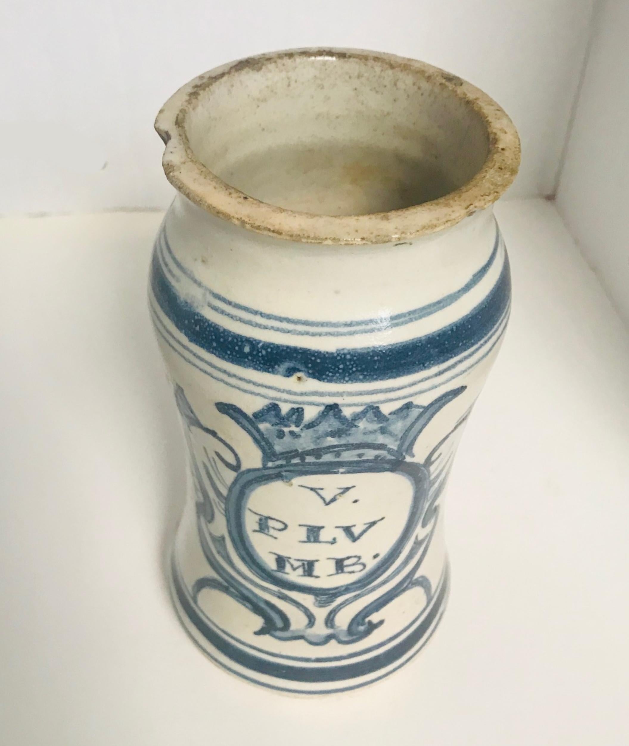 17th century Italian Majolica Albarello Apothecary jar

Antique albarello from the 17th century Italy served both functional and decorative purposes. This one is embellished with a hand painted blue design over a white ground. The storage vessel