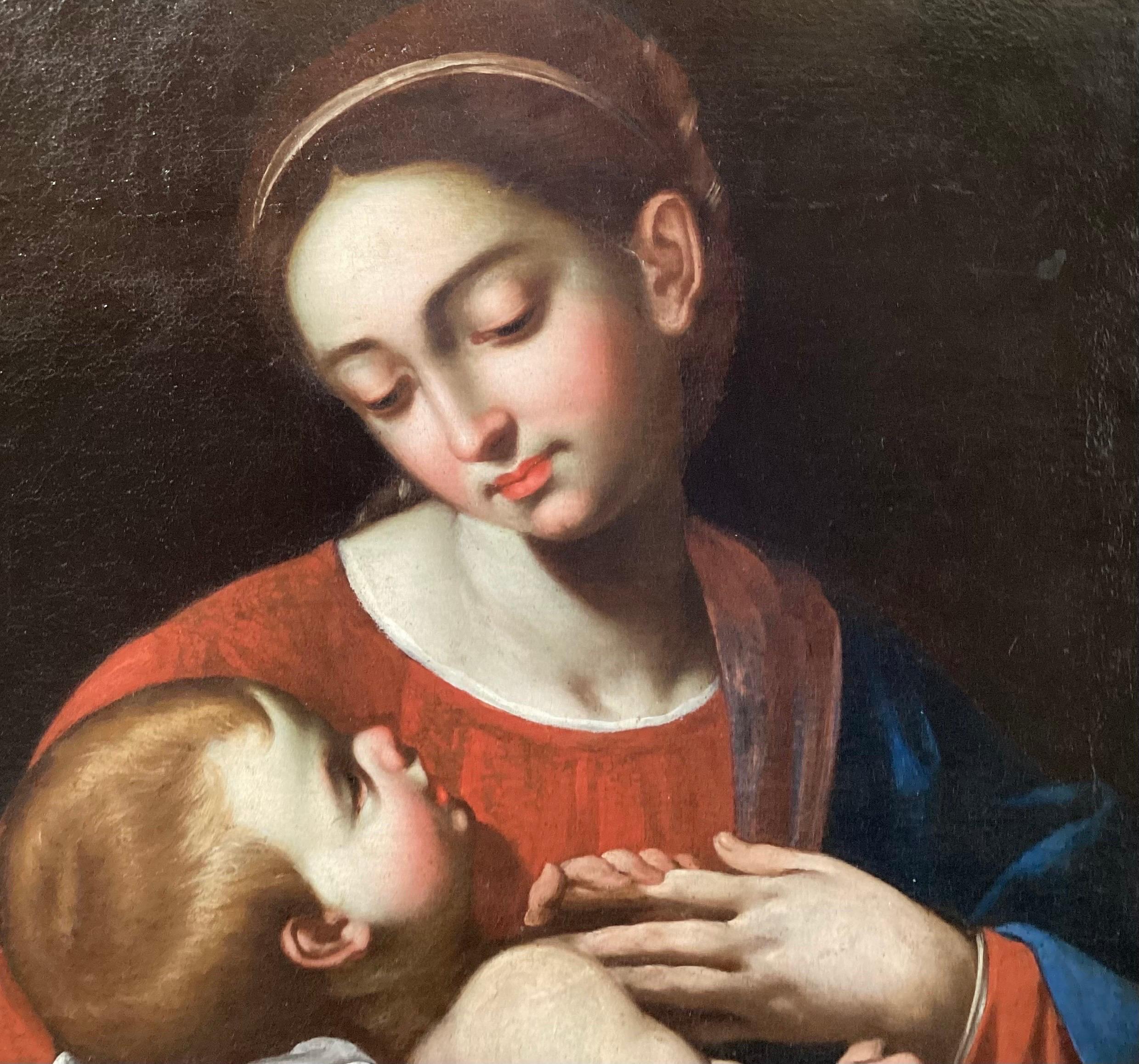 A 17th Century Italian old master painting of Madonna and Child.  The early painting has been cleaned, restreached and relined and has an early frame that may or may not be original.  The painting is bright and the colors vibrant with the recent