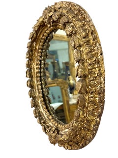 17th Century Italian Oval Giltwood Mirror with Floral Carvings