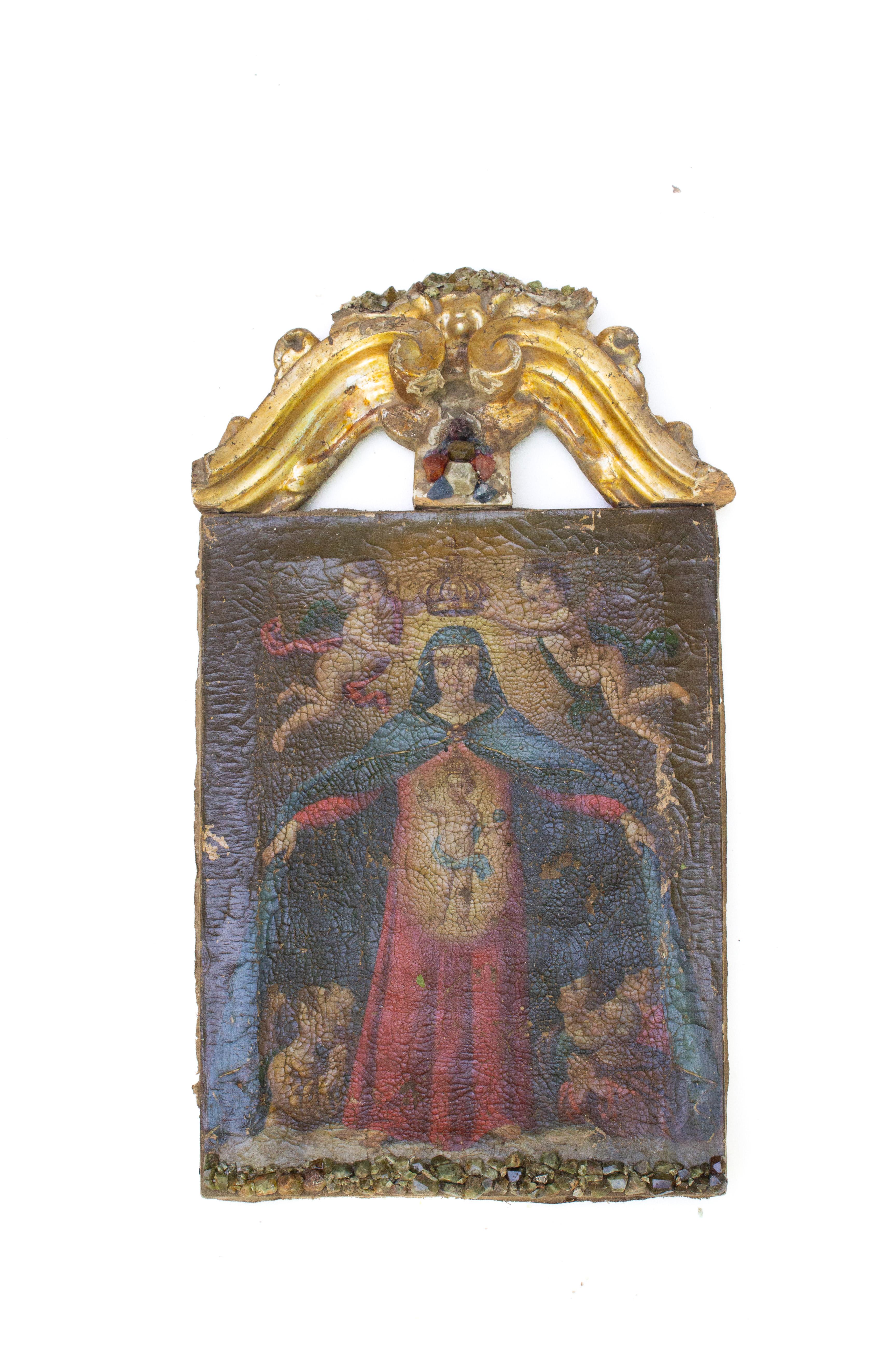 17th century Italian painting of Jesus and Mary adorned with an 18th century Italian gold leaf pediment and bejeweled with green sapphires, carnelian pebbles, garnet, and fluorite. 

The painting depicts Christ inside of the Virgin Mary as he is