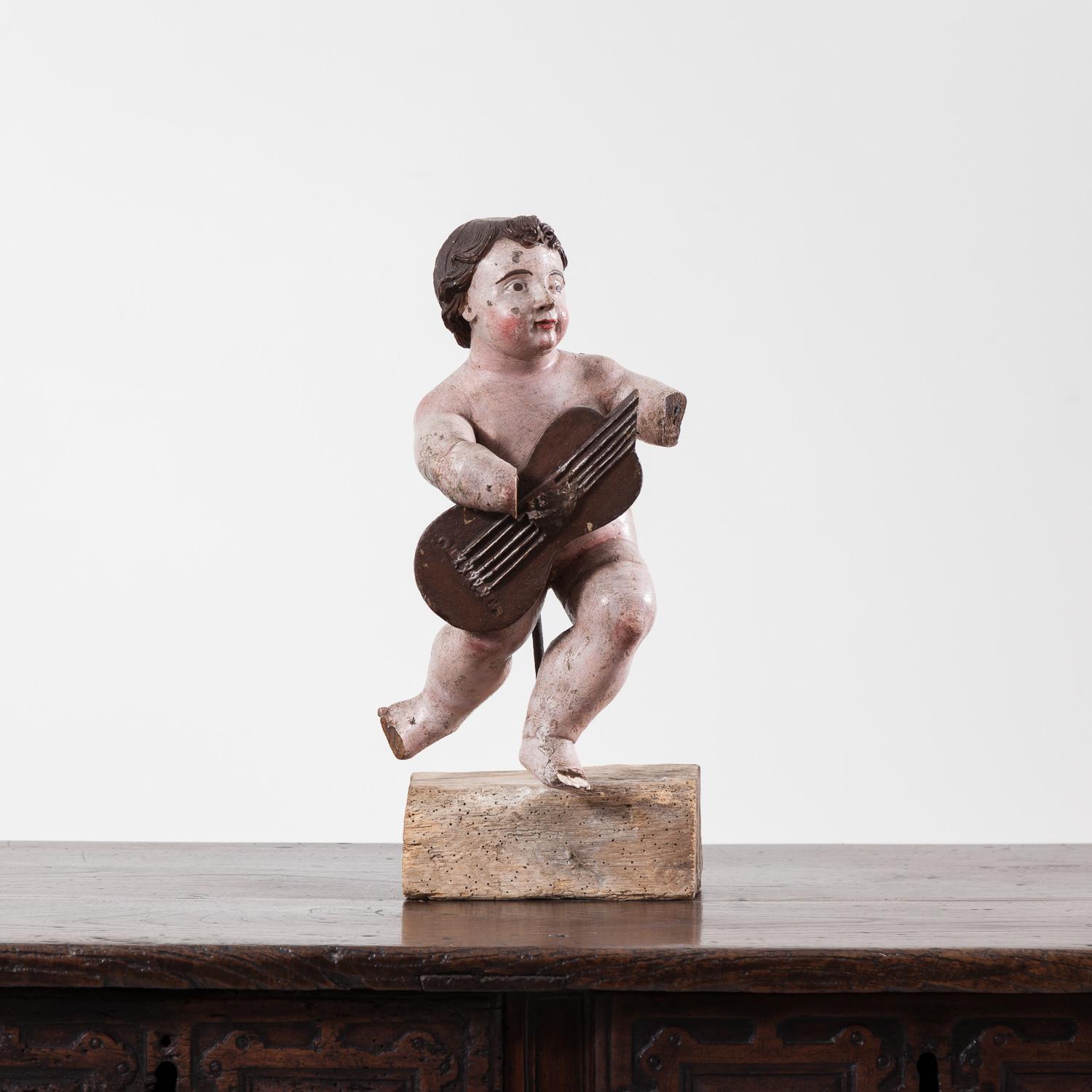 Fine late 17th century Italian carved putto. The piece has been re-painted, most likely in the 19th century.

The figure measures 42cm high on its own and 51cm high including the base.