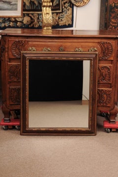 17th Century Italian Rectangular Brown Painted and Carved Parcel Gilt Mirror