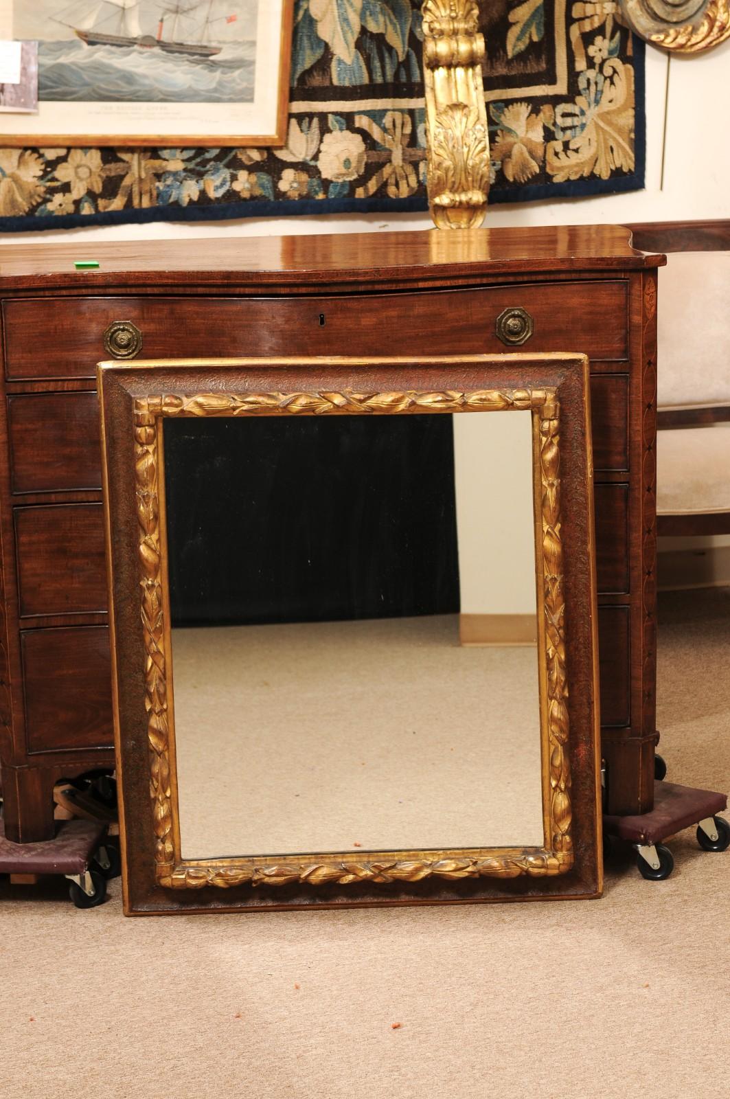 17th Century Italian Rectangular Brown Painted and Carved Parcel Gilt Mirror Italiano en venta