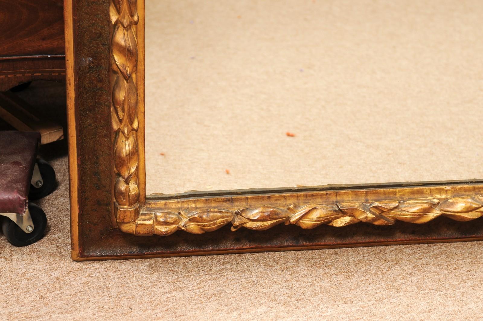 17th Century Italian Rectangular Brown Painted and Carved Parcel Gilt Mirror siglo XVIII y antes en venta