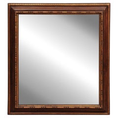 17th Century Italian Rectangular Brown Painted and Carved Parcel Gilt Mirror