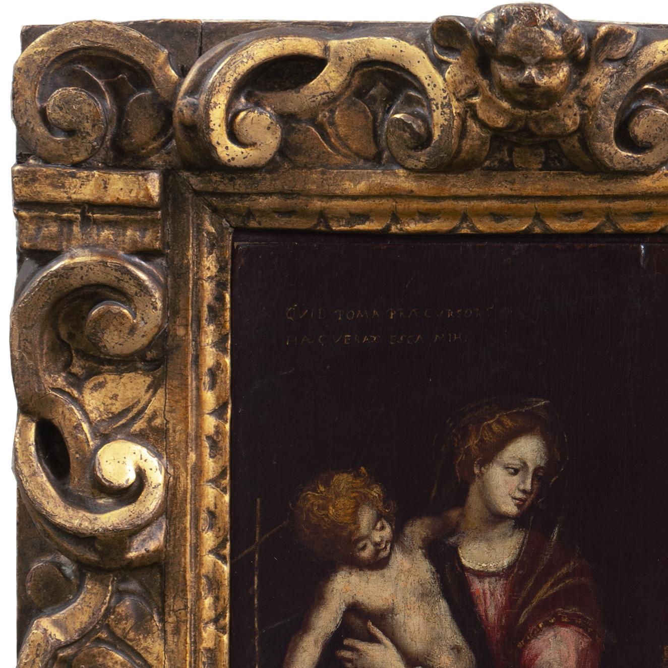 A late 17th century, devotional oil showing the Virgin Mary with Jesus and St. John the Baptist.  Displayed in a fine and period, hand-carved and gilt-wood frame.

The Virgin cradles the young Christ who holds St. John's long cross.  St. John,