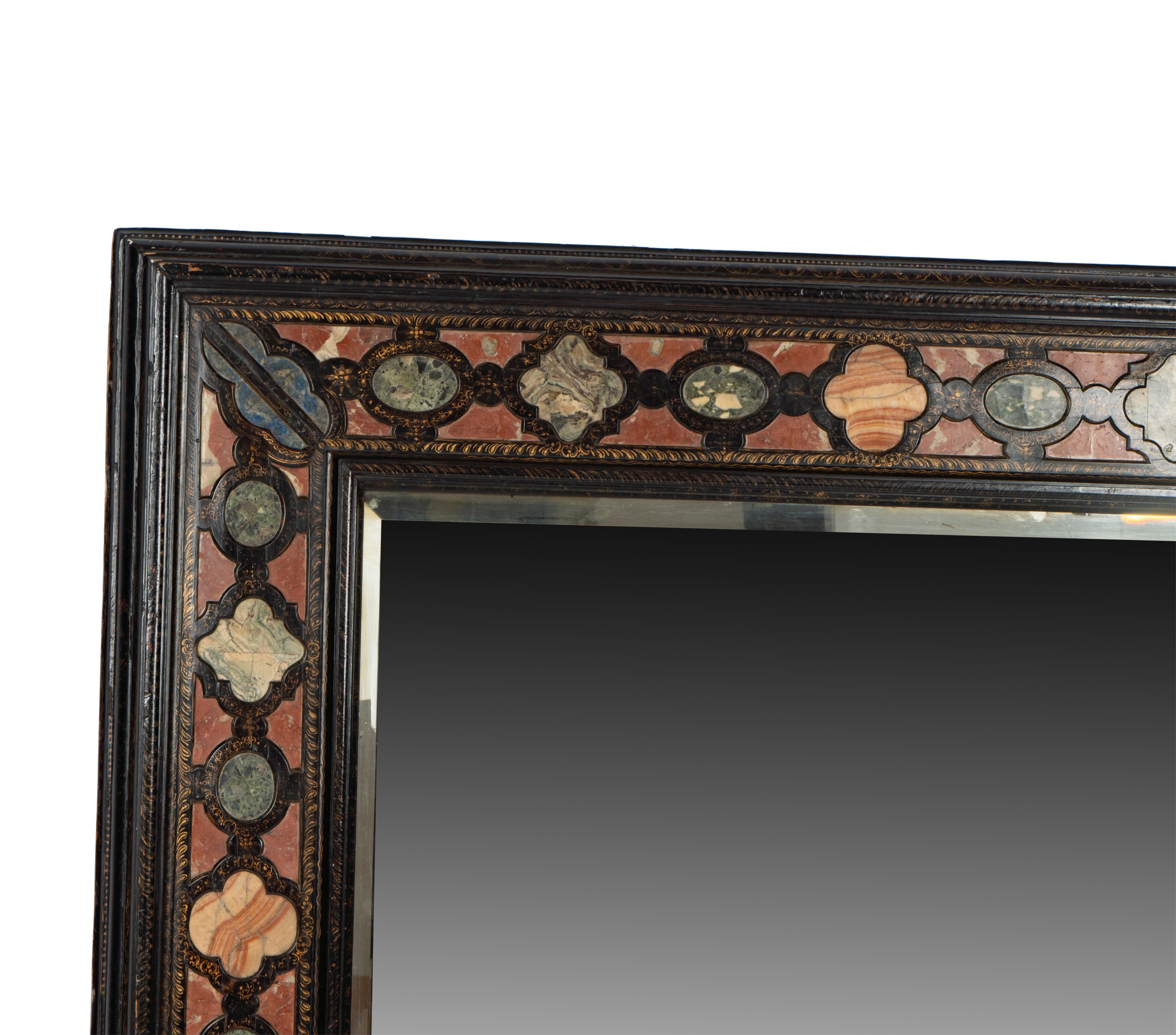 17th century Italian specimen stone-inset and gilt-decorated ebonized wood wall mirror. Provenance Keith Skeel Collection.  Previous Beverly Hills Installation by Micheal Smith.