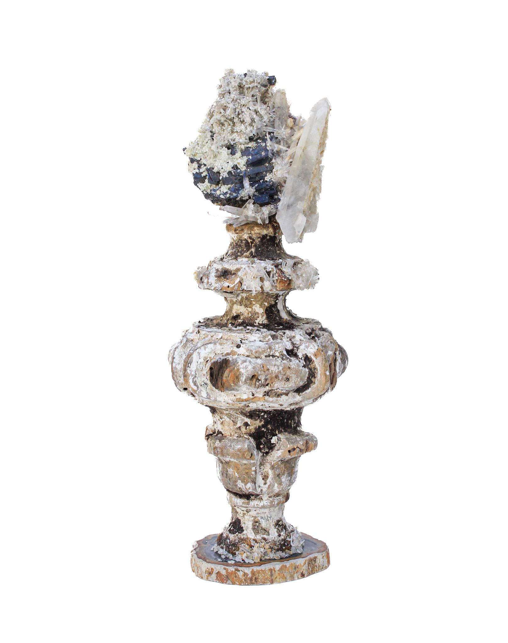 17th century Italian vase with black tourmaline and crystals on a petrified wood base

This fragment is from a church in Florence. It was found and saved from the historic flooding of the Arno River in 1966.

The piece has been naturally