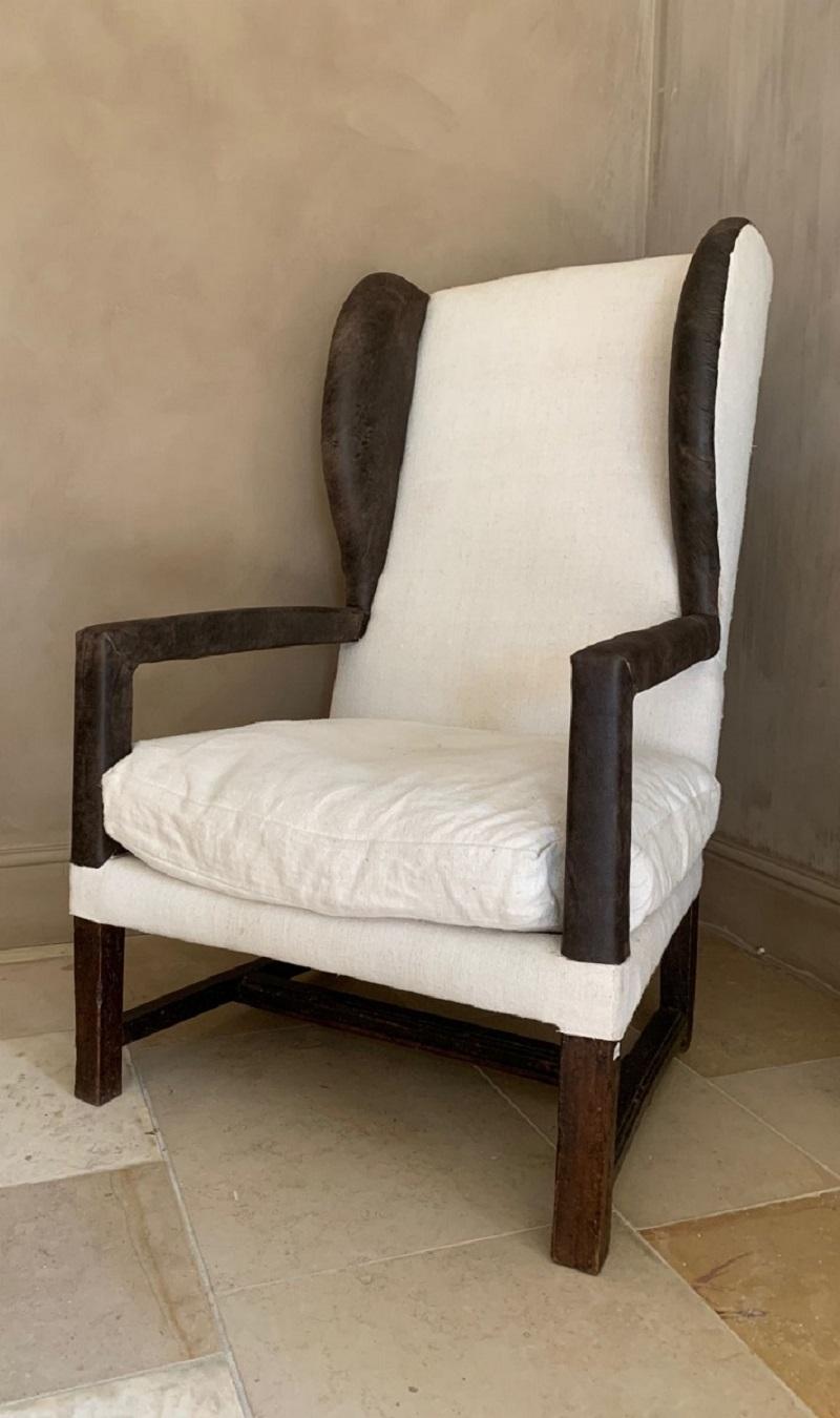 This Italian 17th century wingchair was made from walnut and newly upholstered with 19th century linen and leather.
From the 17th century on comfortable seating was becoming more available (even though the 18th century most of the people only had
