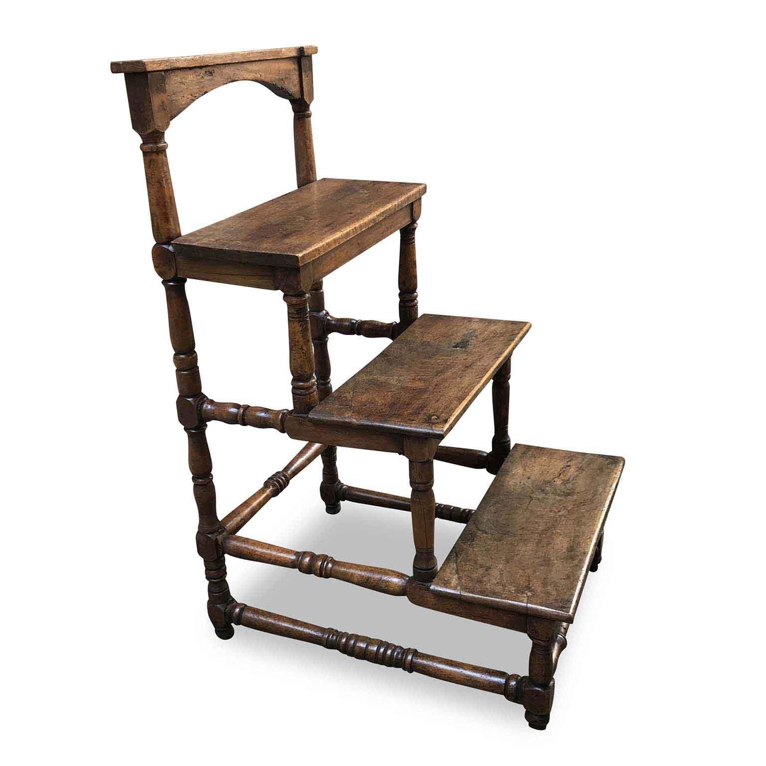This rare four small stairs have decorative solid walnut turned structure in the Italian Baroque Rocchetto style. The 17th century Italian walnut piece comes from Tuscany, Florence and shows old restorations and a first small step made in oak,