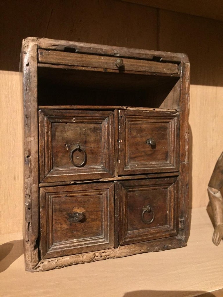 Rustic and delicate miniature travel cabinet. Very finely executed in large boards of fine walnut. All sides traditionally dovetailed. The design, fabrication method and patina of this piece date it to the 17th century.
 