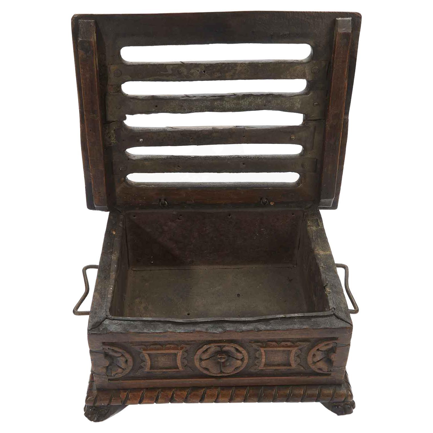 Early 17th century hand carved walnut foot warmer of Northern Italian origin, it looks like an antique box but features a metal container inside, and it was commonly used in Italian noble families of 1600 as warmer, to hold hot coals or glowing