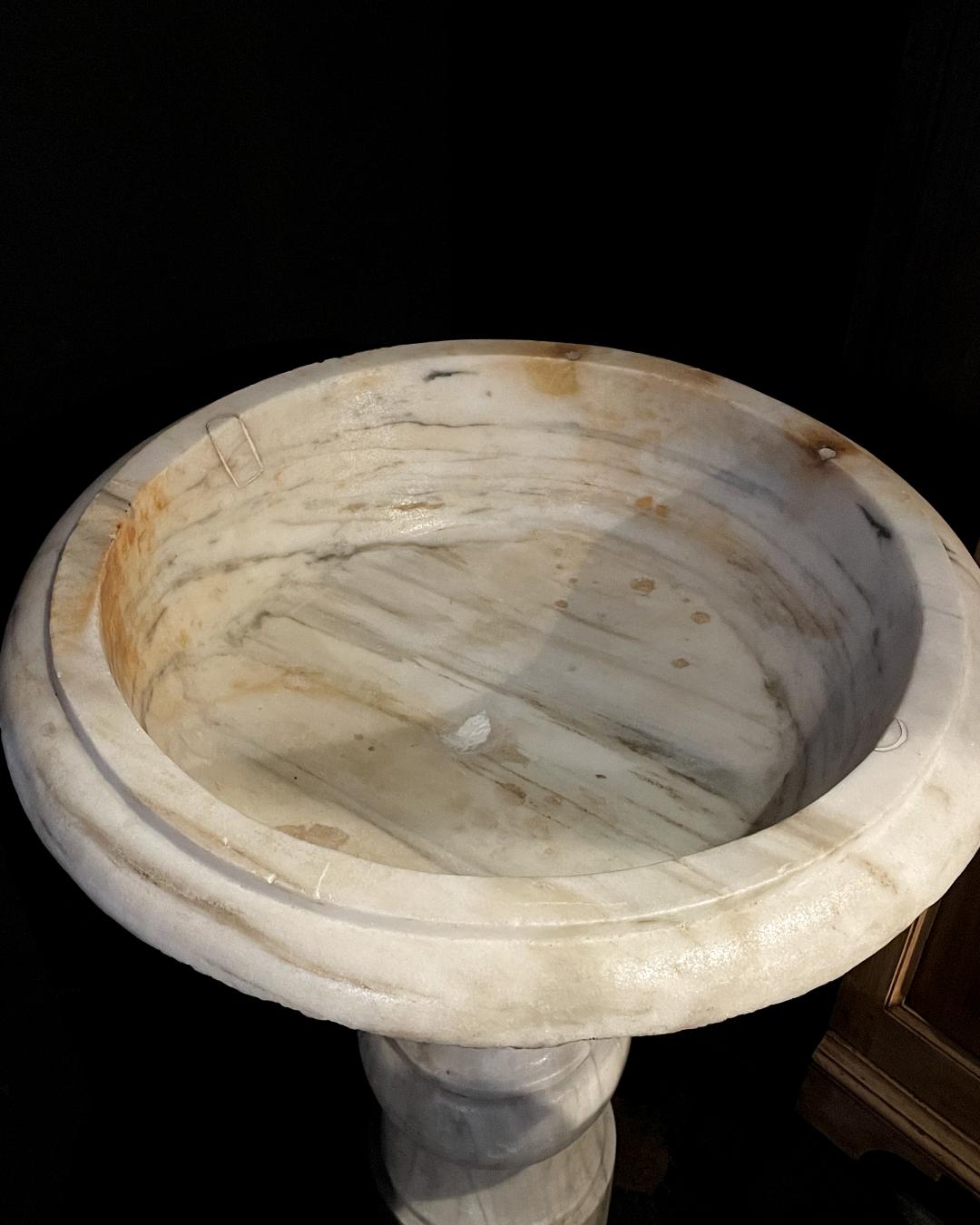 Immerse yourself in the captivating allure of our 17th-Century Italian White Marble Baptismal Font, a remarkable piece that transports you to the artistic splendor of 17th-century Italy. Meticulously crafted, this font showcases a harmonious blend