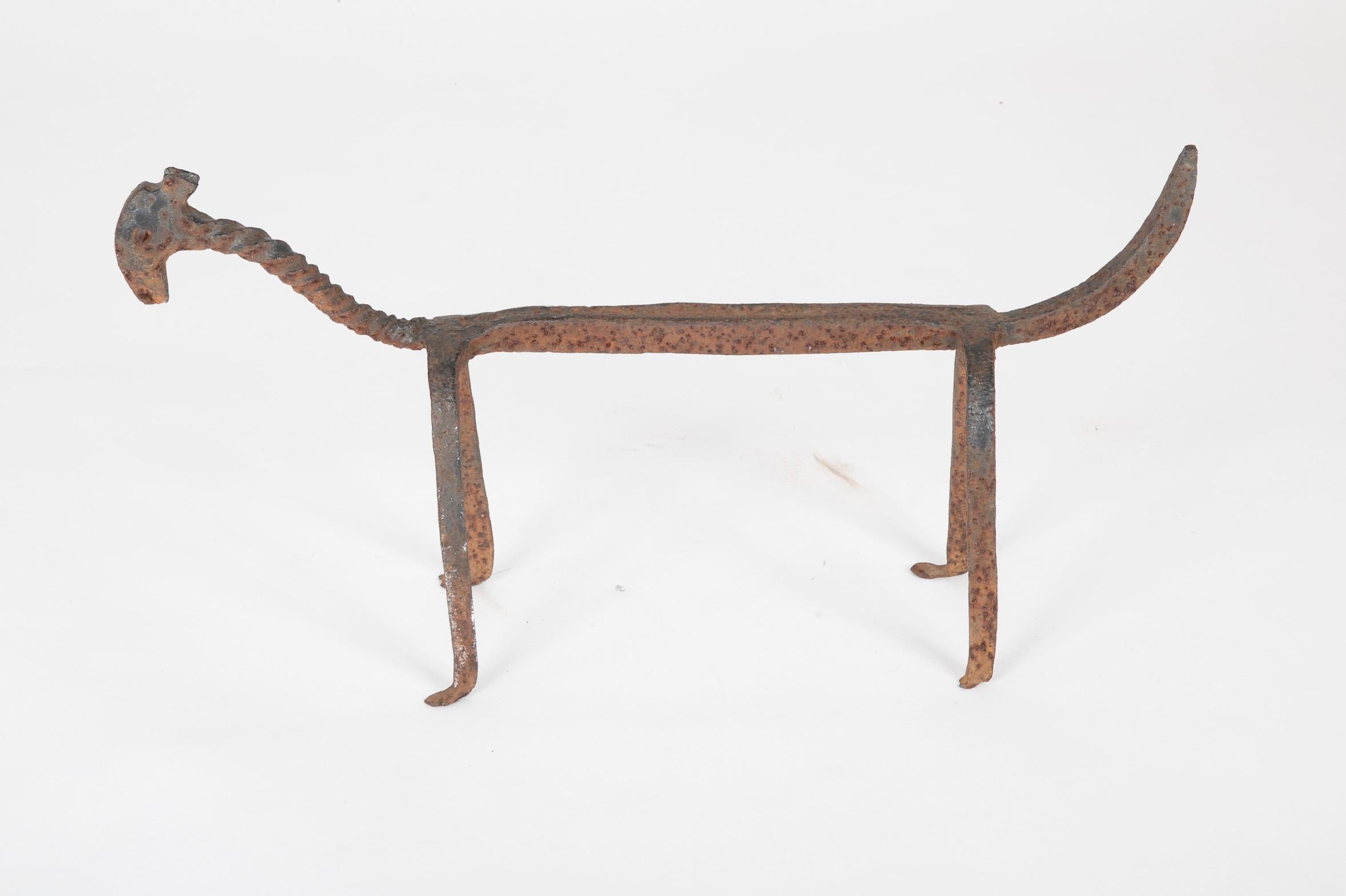 A wonderful anthropomorphic log rest or andiron in the form of a dog. This is a fully realized piece of sculpture with real charm and personality. Like a great piece of Outsider Art. 17th century Italian. 
Measures: 16.75 inches long by 8 high and