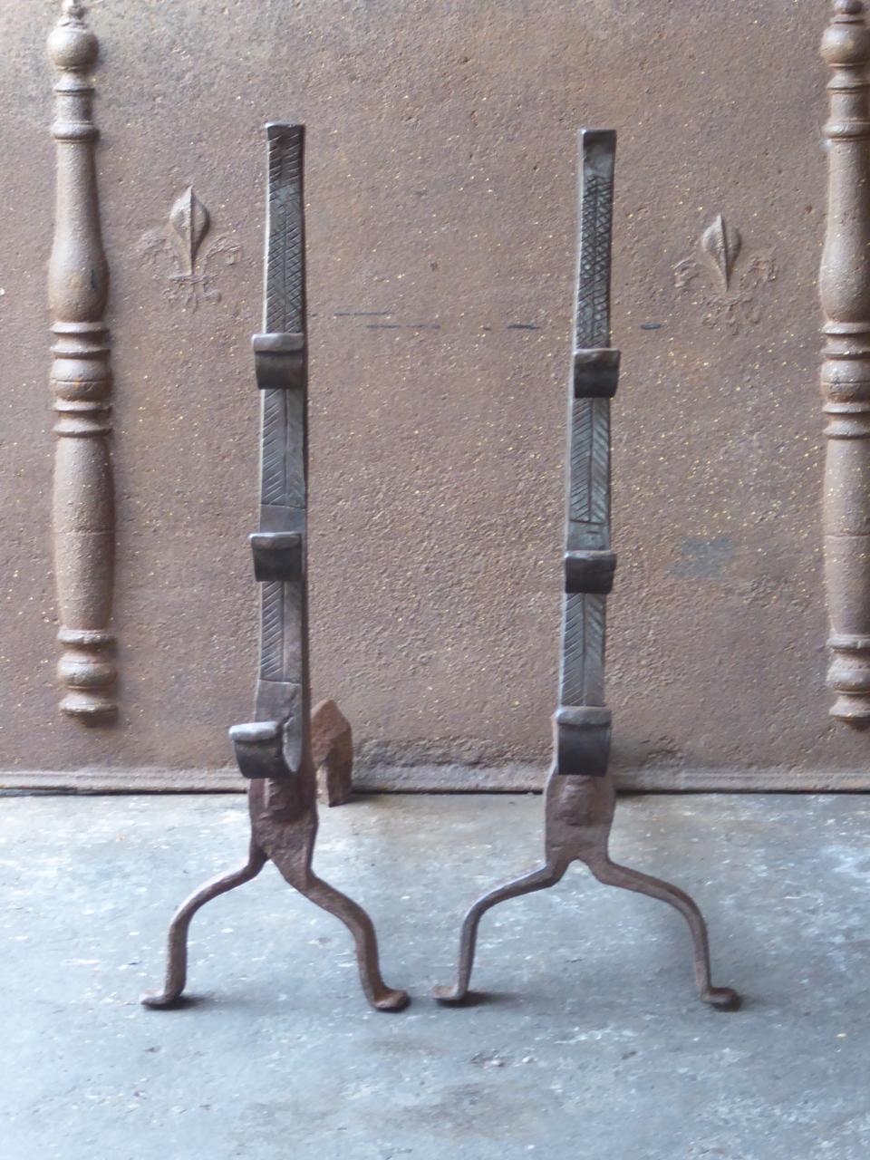 17th century Louis XIII Andirons, firedogs. These French andirons are called 'landiers' in France. This dates from the times the andirons were the main cooking equipment in the house. They had spit hooks to grill meat or poultry and sometimes a cup