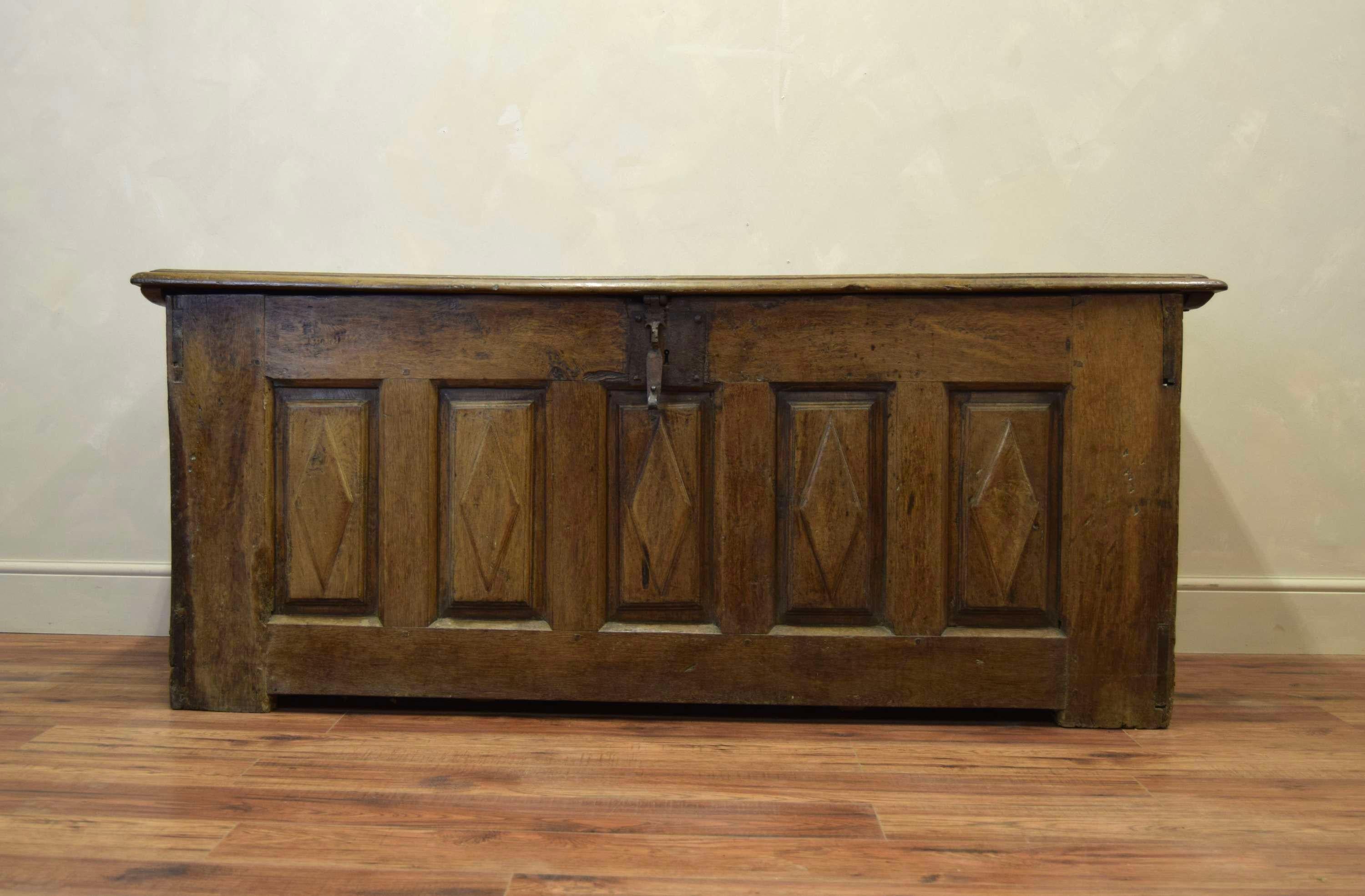 Extraordinary scale and gauge, 17th century oak coffer.
Primitive iron mongery.
Simple, diamond detail, carved wood panelling to front and sides.
Clean and solid.
Hand Carved 
Dimensions:H: 81cm (31.9