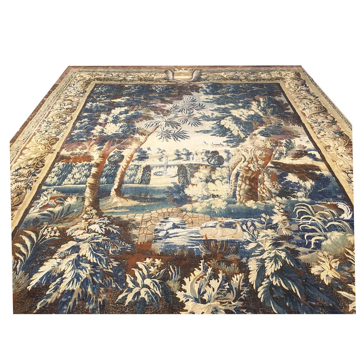 Ashly Fine Rugs Presents AN ENGLISH BAROQUE GARDEN LANDSCAPE TAPESTRY, ROYAL MORTLAKE WORKSHOP, 17TH CENTURY, woven with silk and wool in a rectangular form centering a stone footbridge over a meandering stream with paired geese amidst a garden of