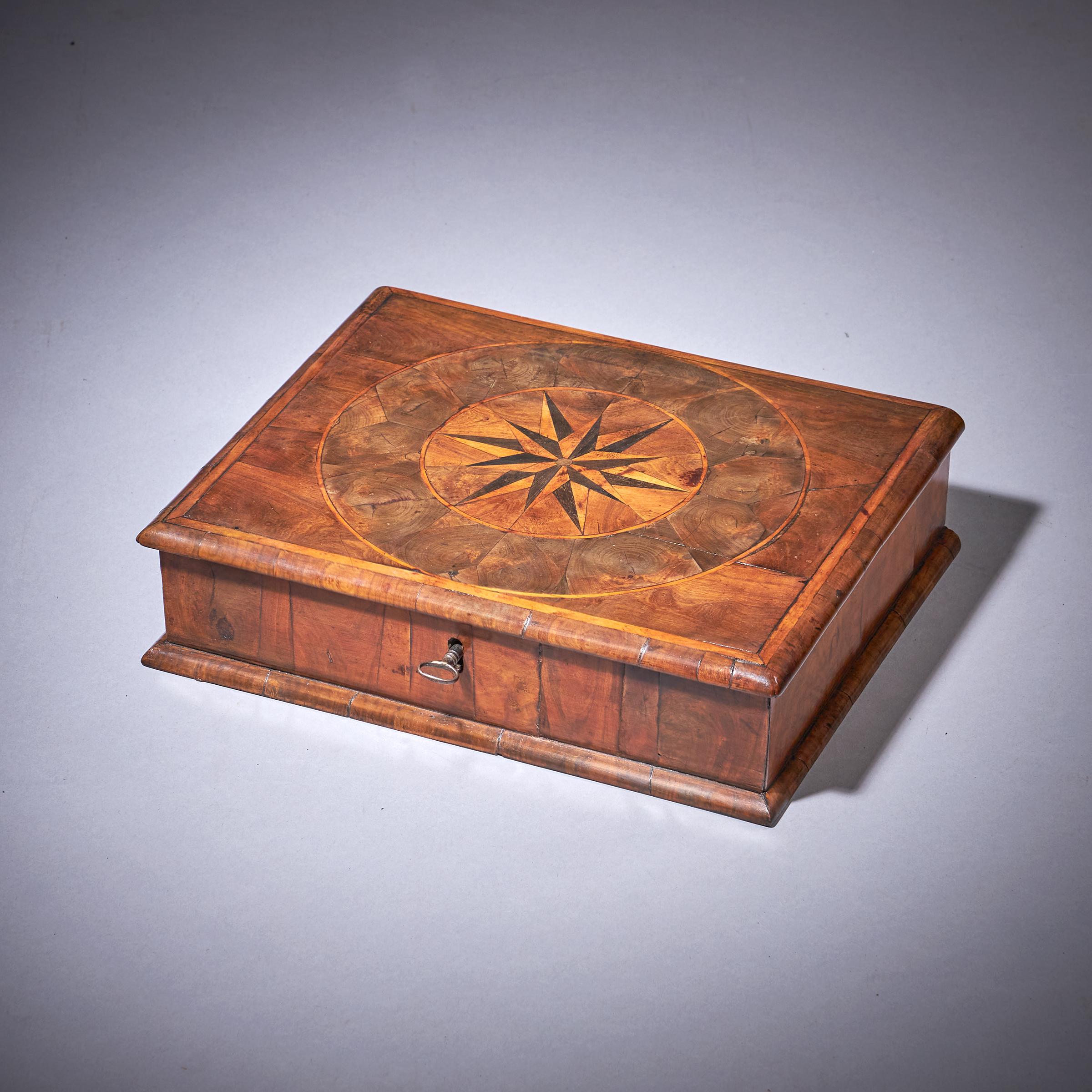 A fine and rare Charles II / William and Mary 17th-century olive oyster lace box of small proportions with parquetry star inlay. C.1670-1700. England

The cross-grain moulded and holly banded top is finely veneered in hand-cut pieces of olive cut