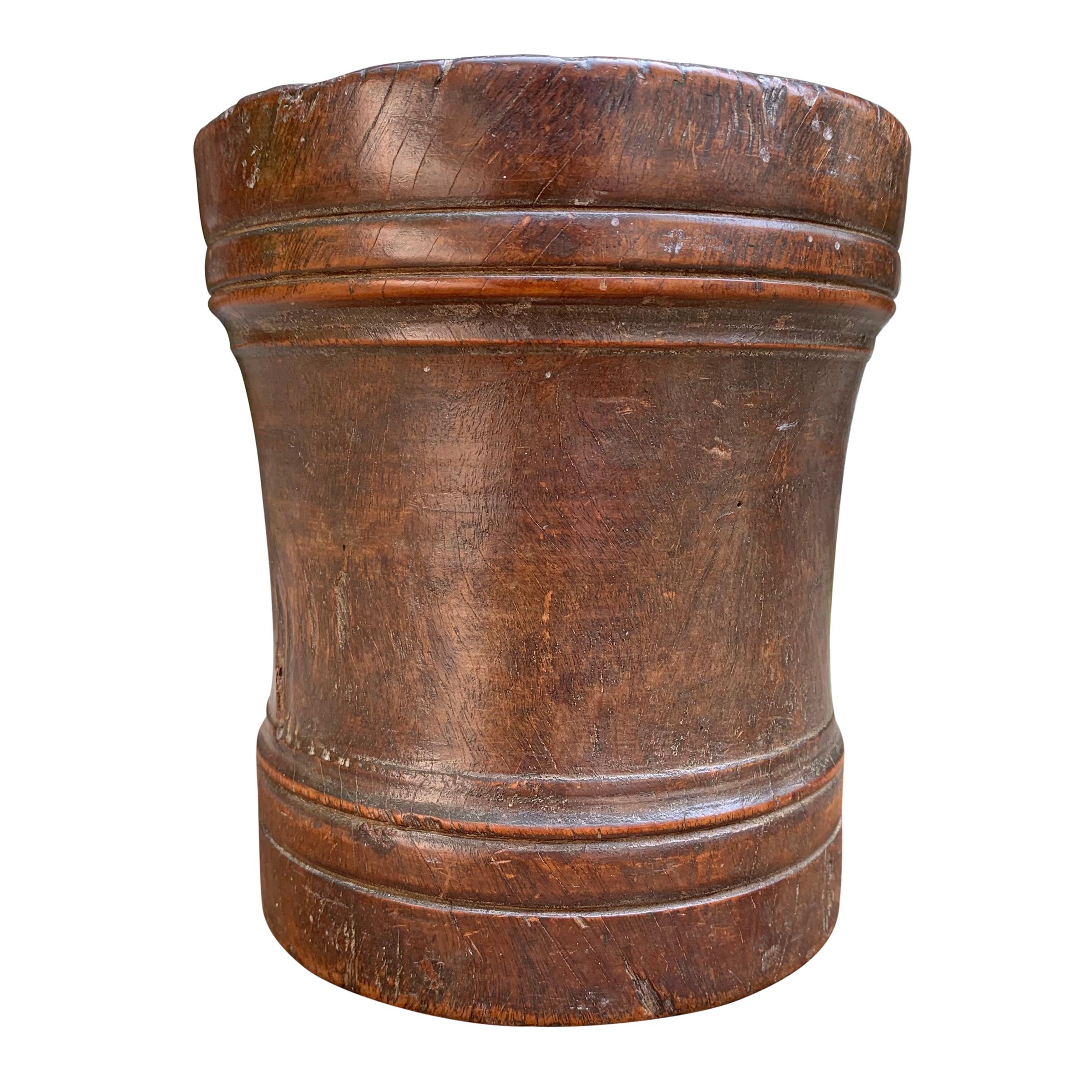 An incredible 17th century English mortar and pestle made from turned lignum vitae, an extremely dense hardwood found in parts of the Caribbean and South America, with incised and raised bands and a patina only four hundred years could bestow.