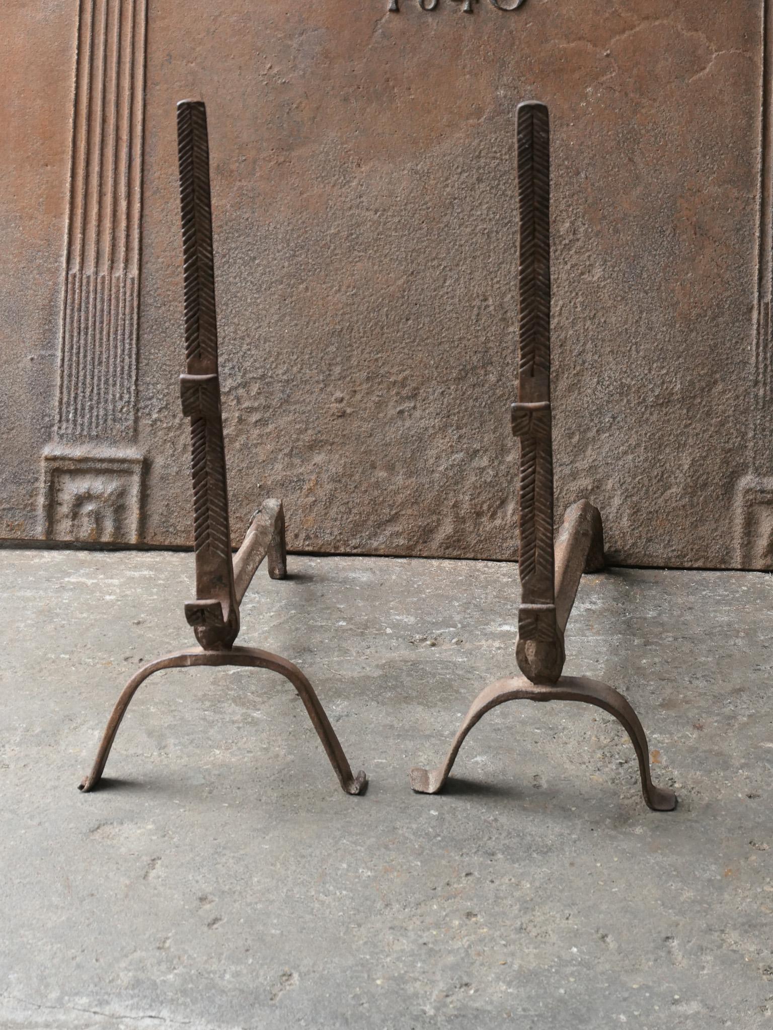 17th century French Louis XIII fire dogs with spit hooks. Made of wrought iron. These French andirons are called 'landiers' in France. This dates from the times the andirons were the main cooking equipment in the house. They had spit hooks to grill