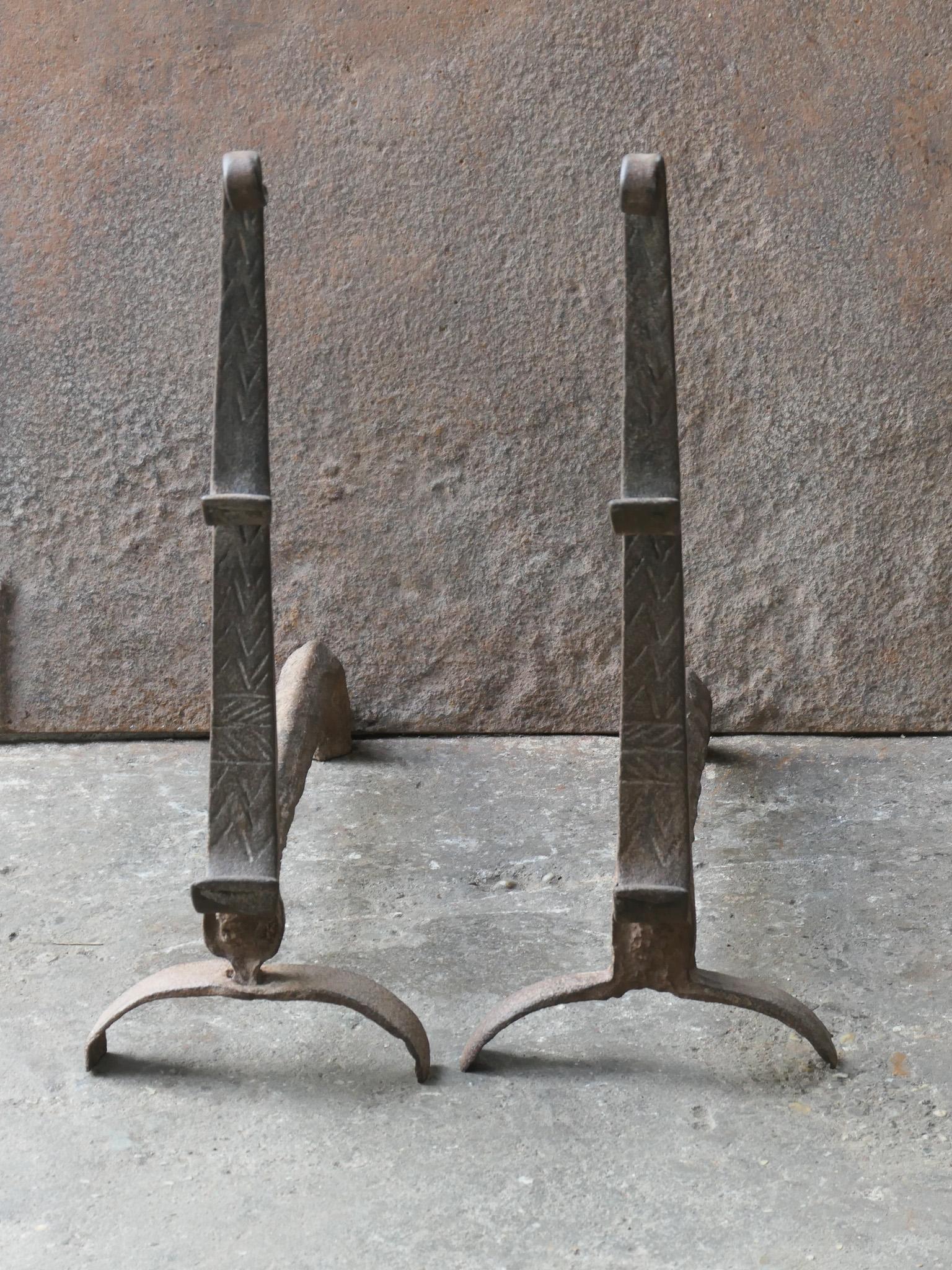 17th century French Louis XIII fire dogs with spit hooks. Made of wrought iron. These French andirons are called 'landiers' in France. This dates from the times the andirons were the main cooking equipment in the house. They had spit hooks to grill