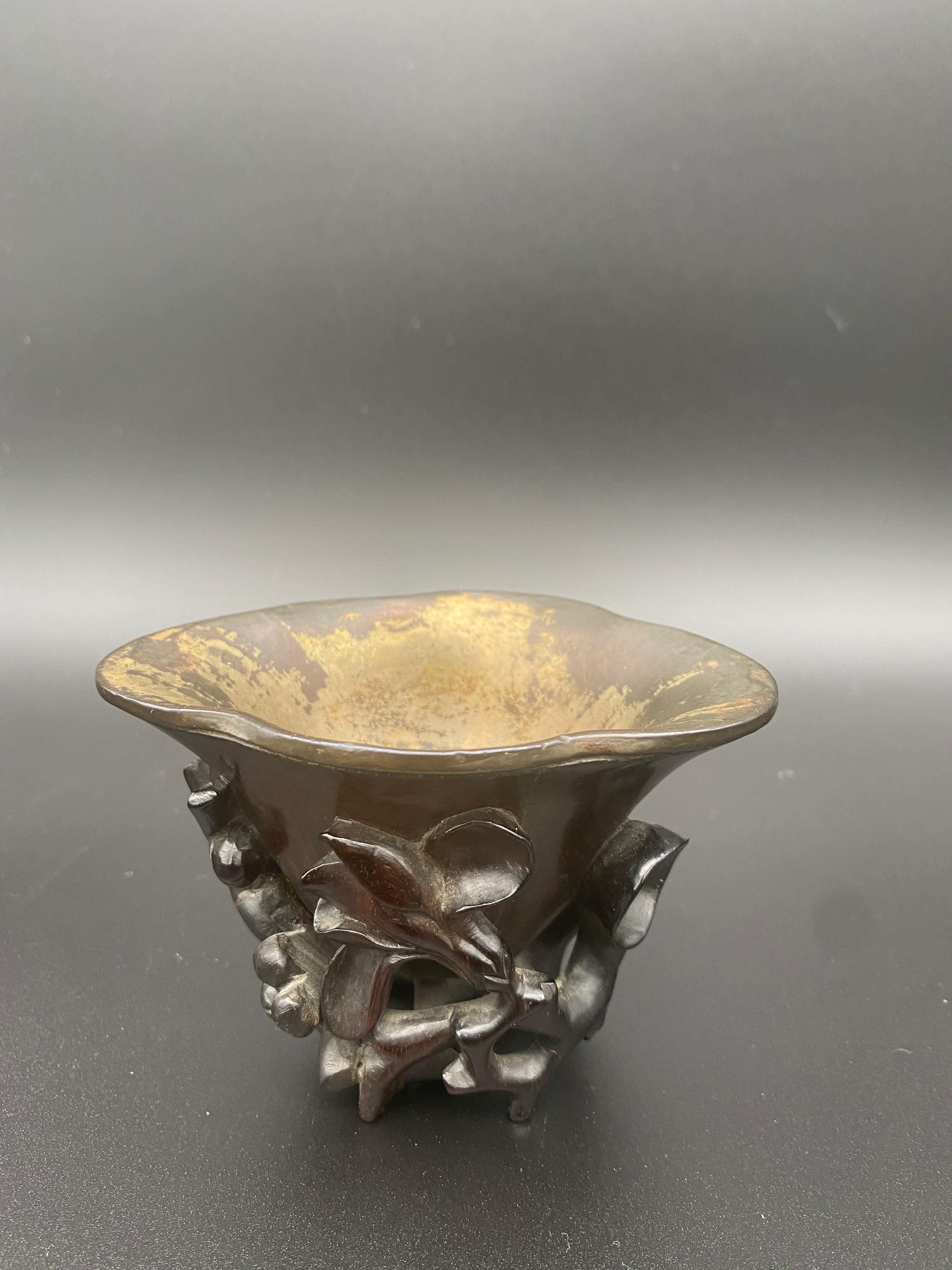 17th century Ming dynasty Chinese Zitan libation cup silver inlaid, of deep oval form , the exterior carved in high relief and undercut around the sides and base with gnarled branches if blossoming magnolia and plum flowers, with silver lining.