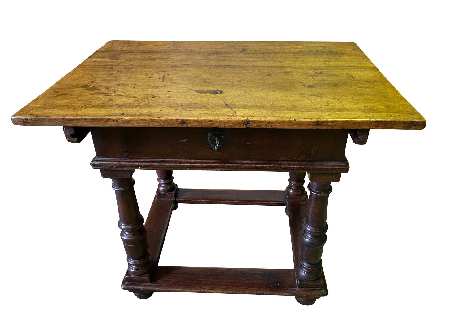 An exceptional 17th century Money Changer's Table from Flanders. Beautifully constructed from walnut and oak. Once unlocked, the top surface slides backwards to expose a configuration of drawers and compartments. The locking mechanism is in itself,