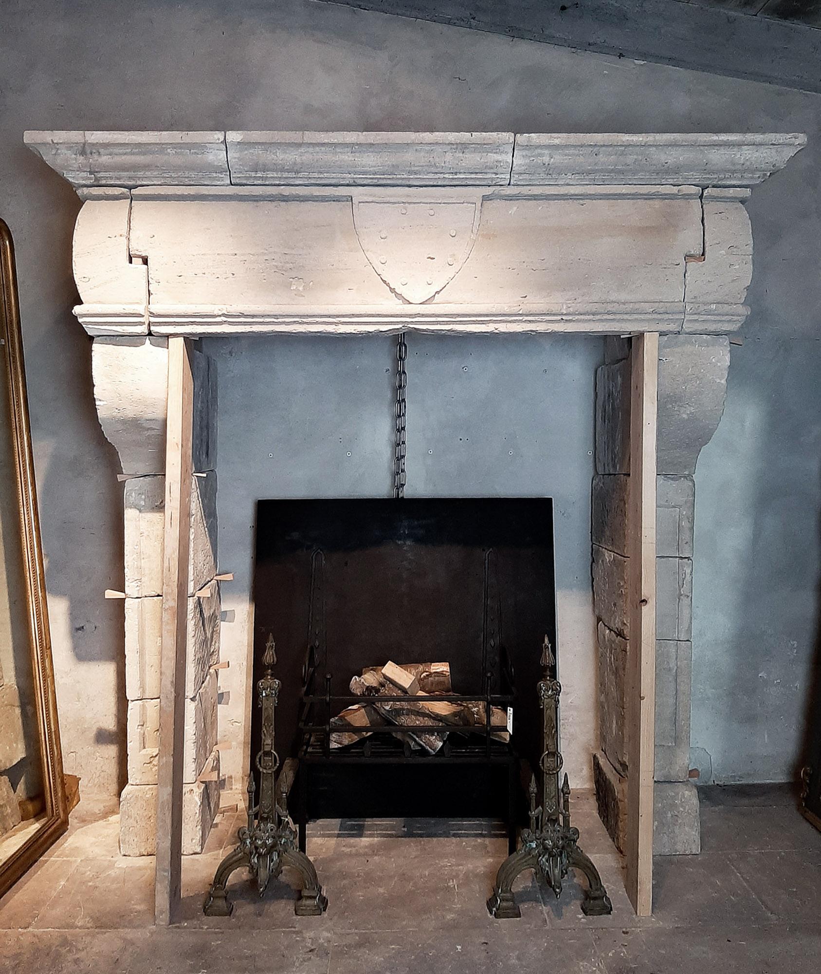 Stunning Antique 17th Century Mantelpiece, a timeless limestone fireplace from France. Featuring a central cartouche with a coat of arms, this piece adds historical charm to any space.  Its simple yet elegant design captures the essence of French