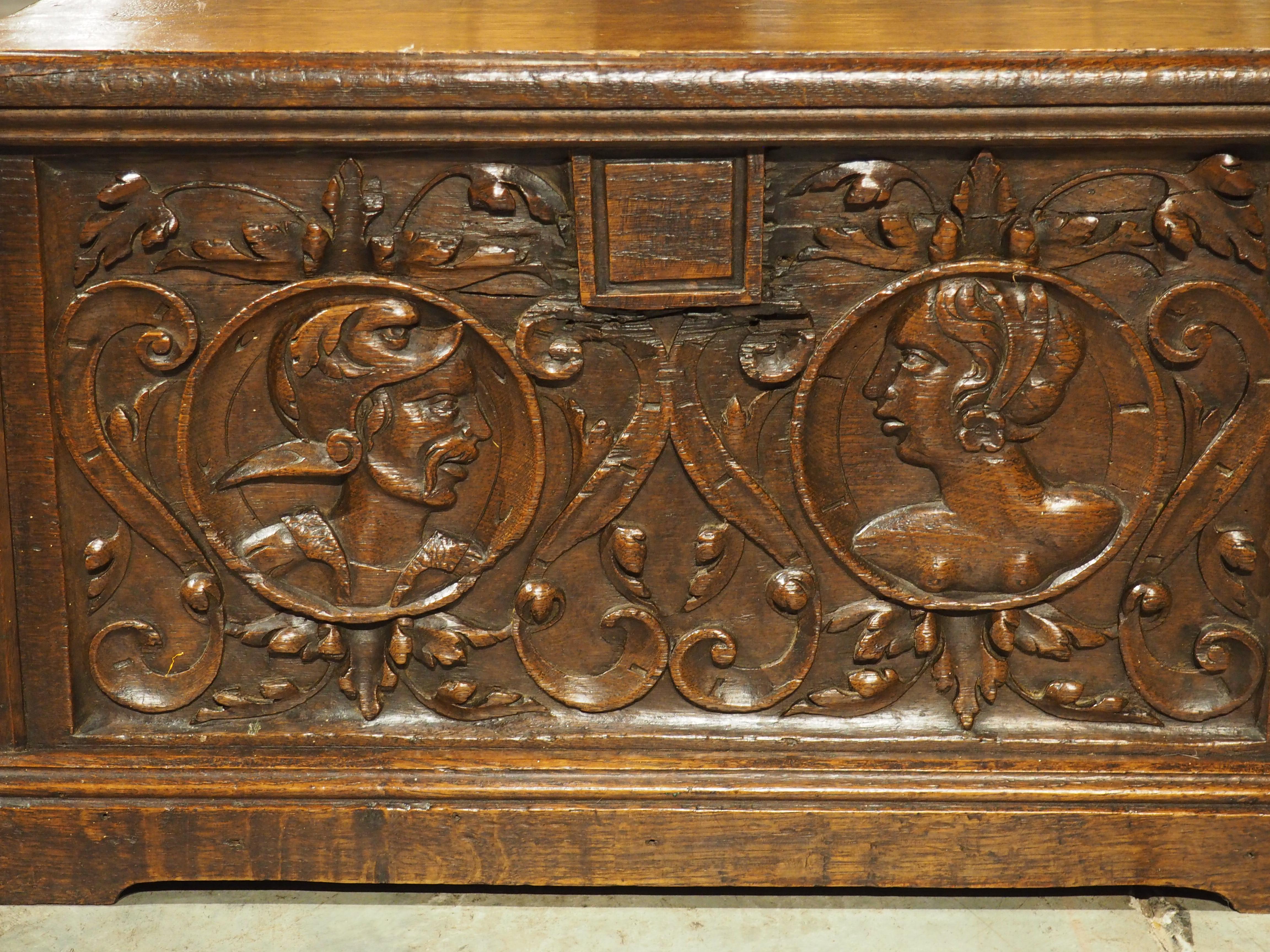 Based on the facing portrait cartouches on the front facade, this chest was most likely presented to a couple for their wedding in 17th-century Northern France. The oak wood has a deep brown patina that accentuates the hand-carved frontage,