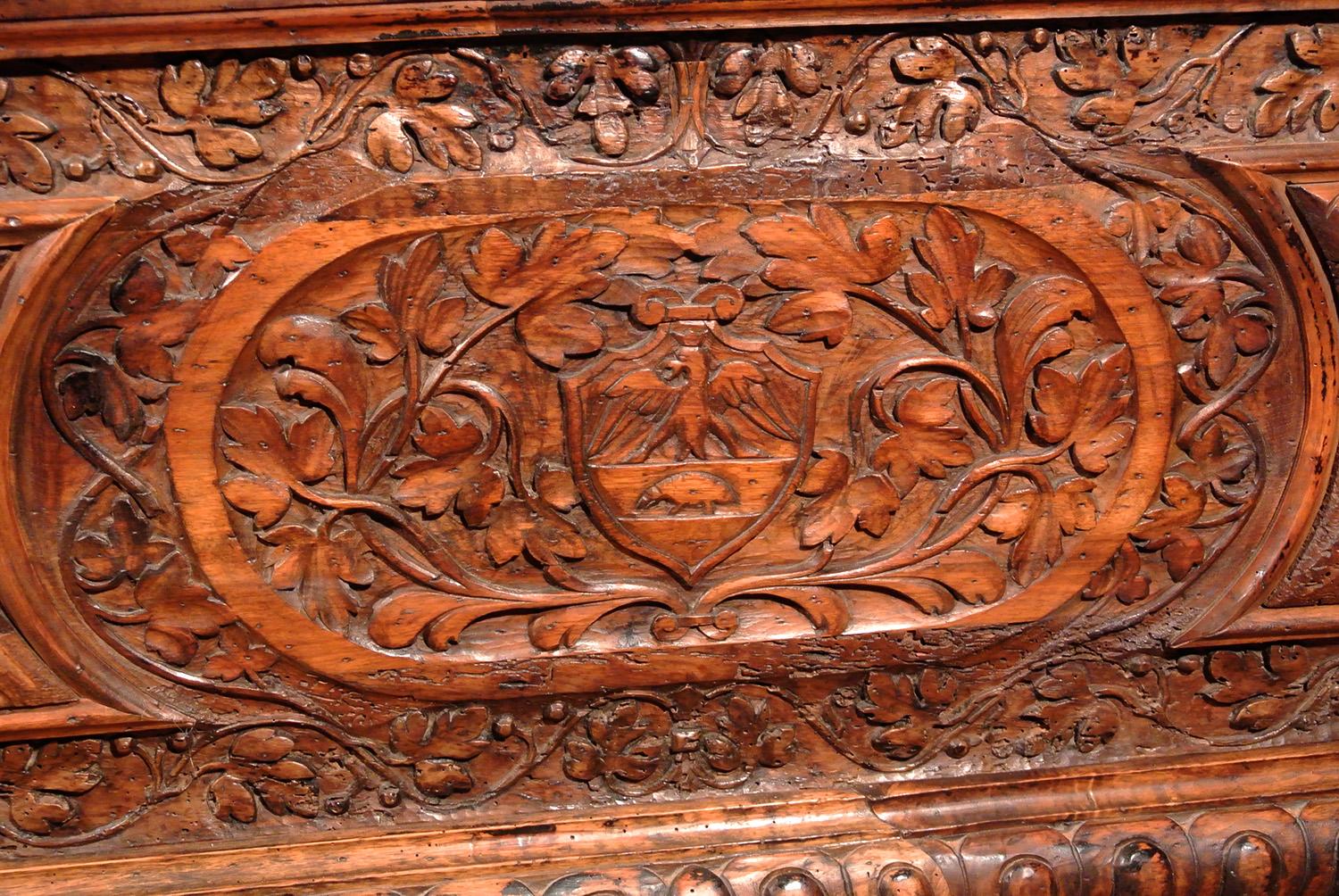 A lovely and early walnut cassone with original single planked top of good color and patination and most attractive gadrooned carving to the front panel and bottom frieze, with beautifully carved oak leaf and vine borders and centred with a oak leaf
