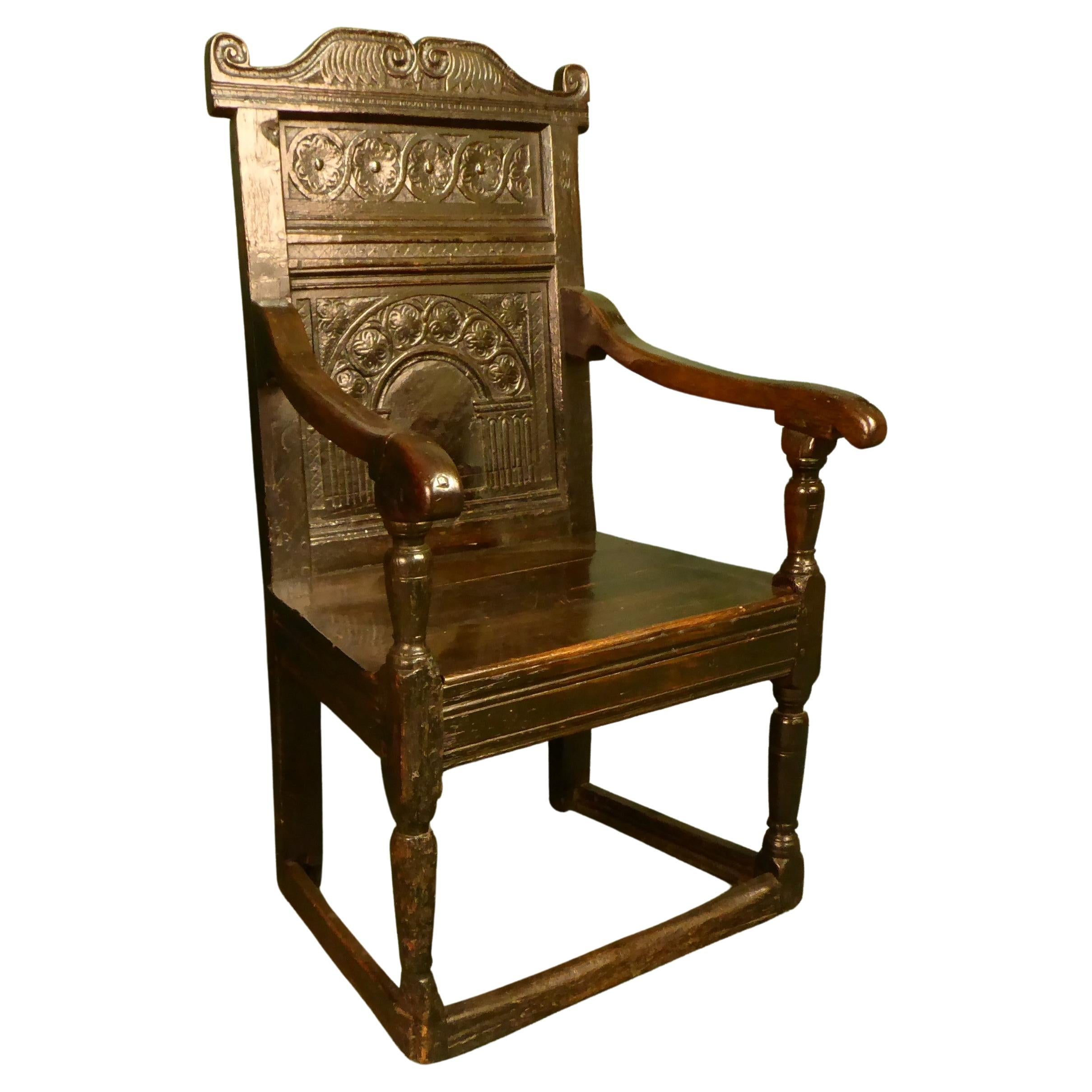 17th, century oak arm chair superbly carved with original patina For Sale