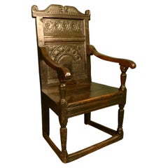 17th, century oak arm chair superbly carved with original patina