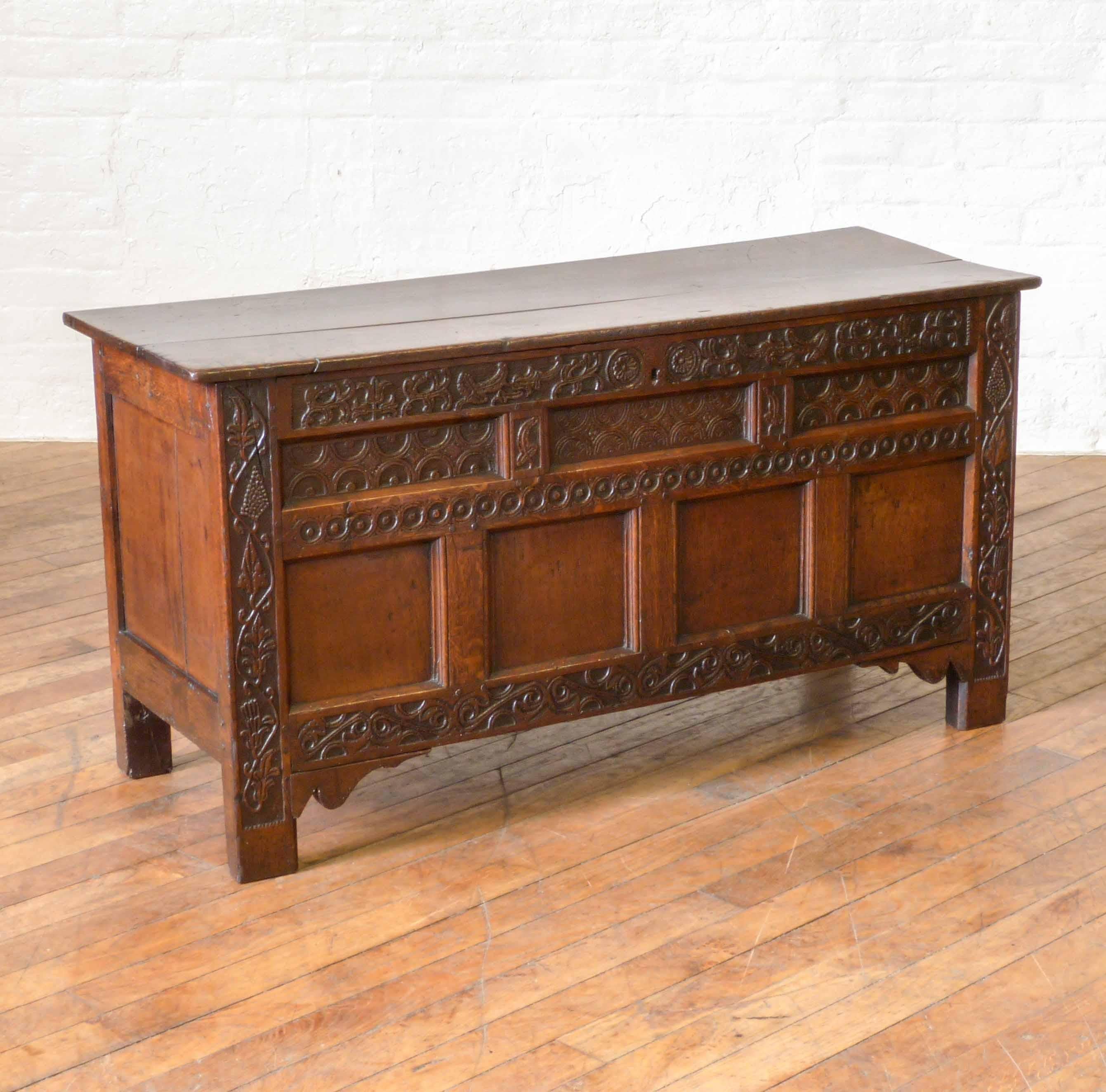 A very attractive 17th century oak coffer of the most wonderful colour and patination. Set off with carved foliage, fruit and geometric designs throughout. This piece is mostly original and has had little restoration for its 300+ years. A piece of