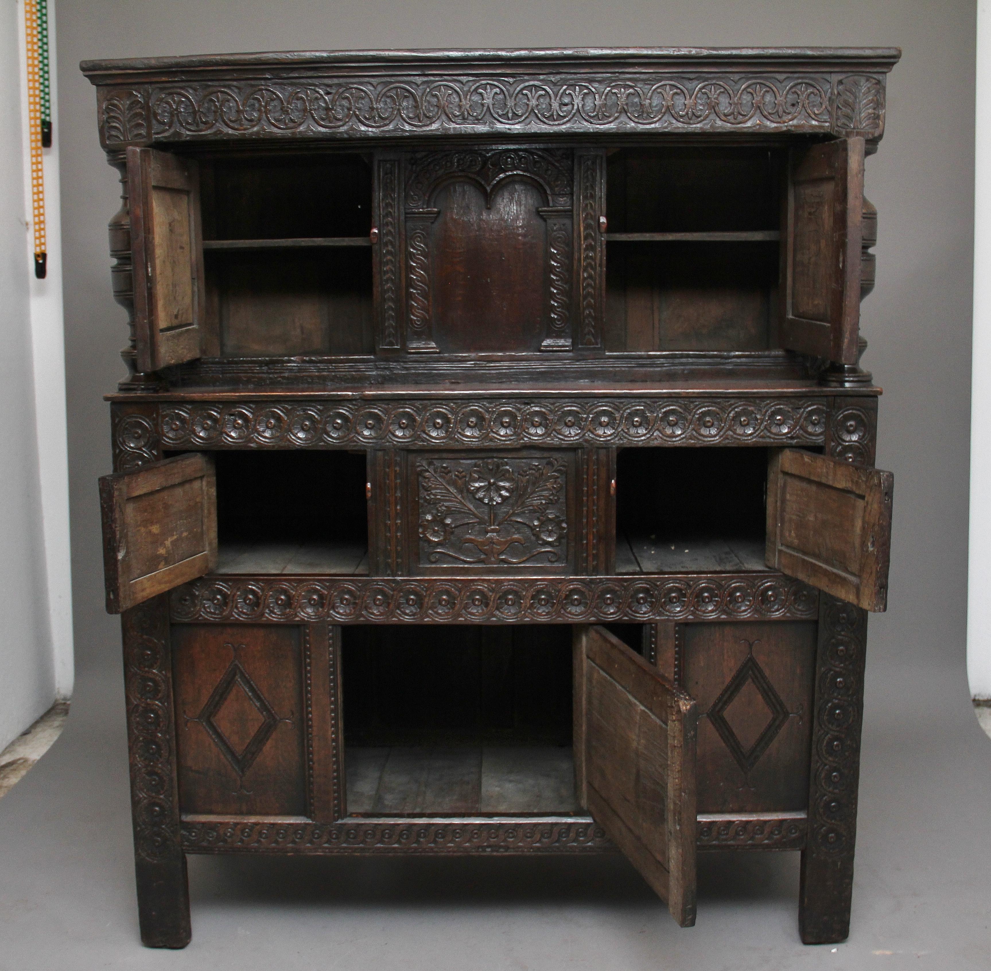 A lovely quality mid-17th century oak court cupboard of good proportions, the cupboard decorated with carved circular decoration, the frieze over two cupboard doors with a carved panel at the centre, flanked by turned columns, the middle section