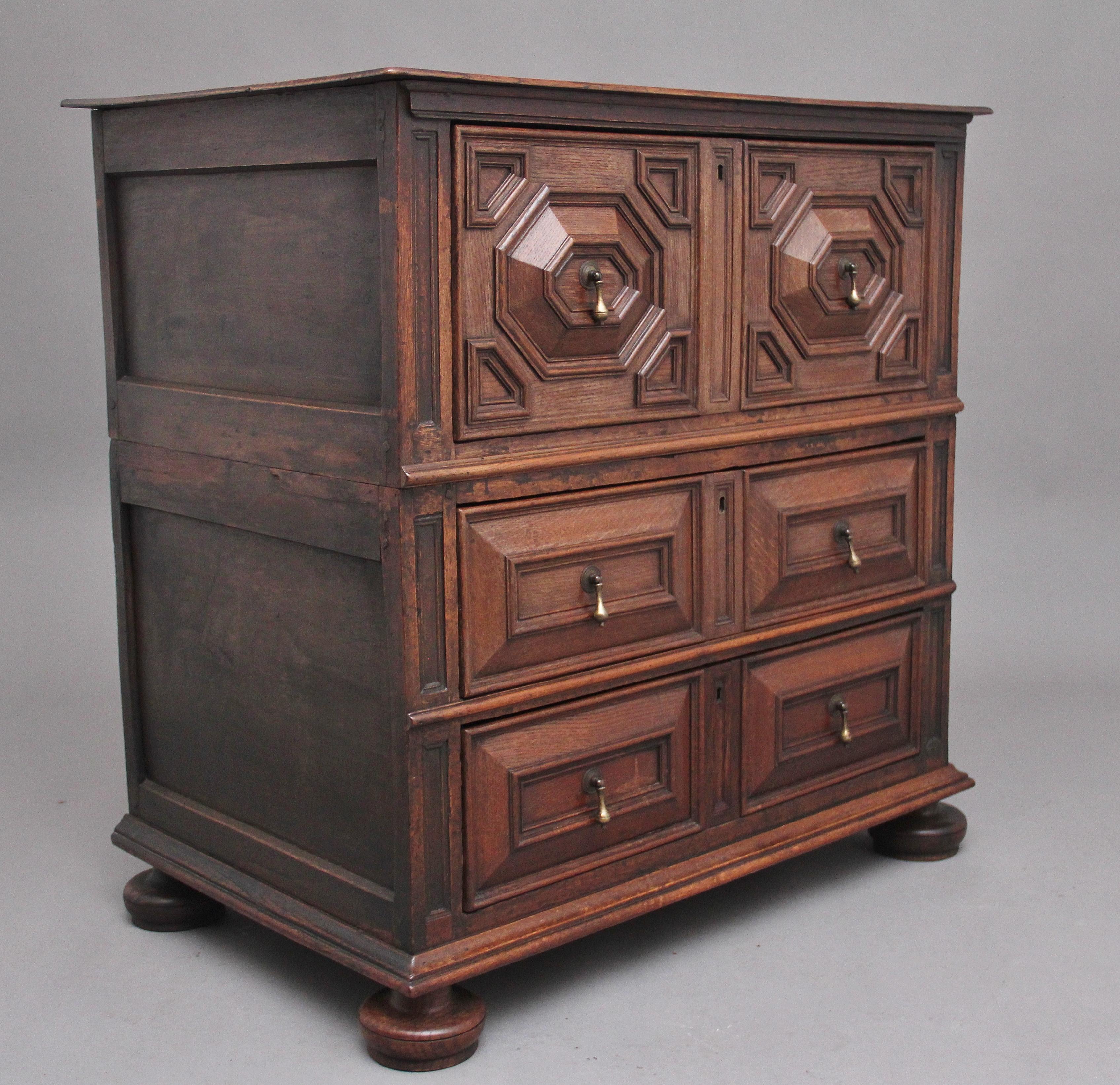 17th Century oak geometric chest of drawers of good proportions, the rectangular top above a deep moulded geometric drawer above two further geometric drawers, raised on squat bun feet. Circa 1670.
